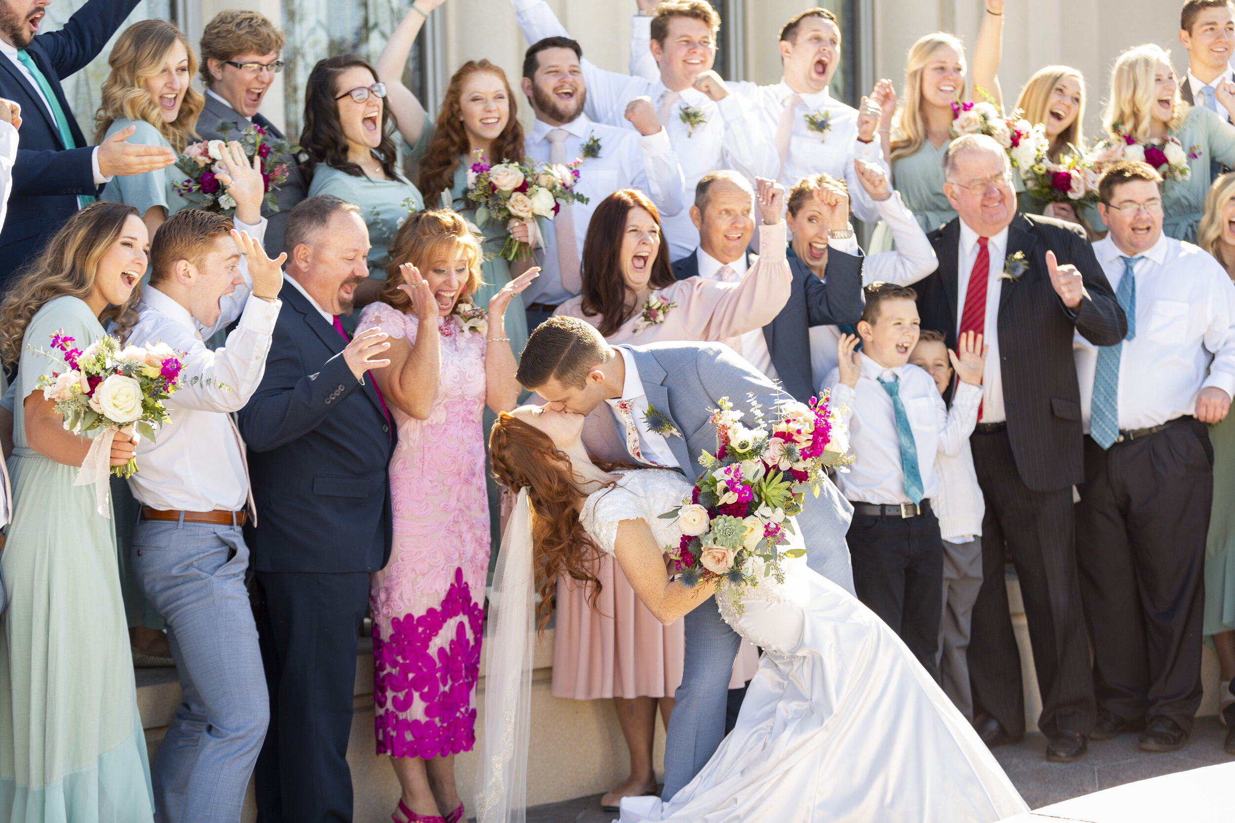   kissing the bride dip pose inspiration wedding day picture inspiration happy family surrounded by family  unique interesting angle inspiration beautiful couple meant to be true loves kiss summer wedding inspiration wedding goals lds wedding inspira