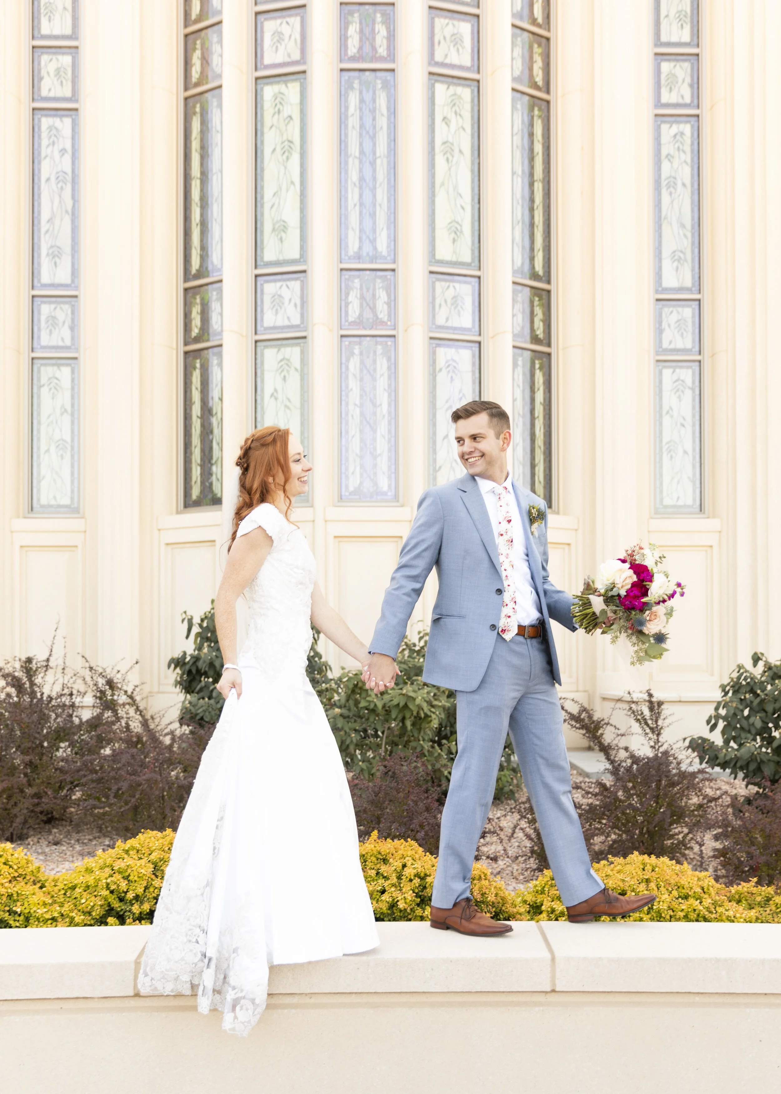  husband holding the bouquet payson temple stained glass windows utah weddings lds wedding mormon wedding wedding day excitement together forever sealed for time and all eternity walking hand in hand wedding dress inspiration summer wedding inspirati