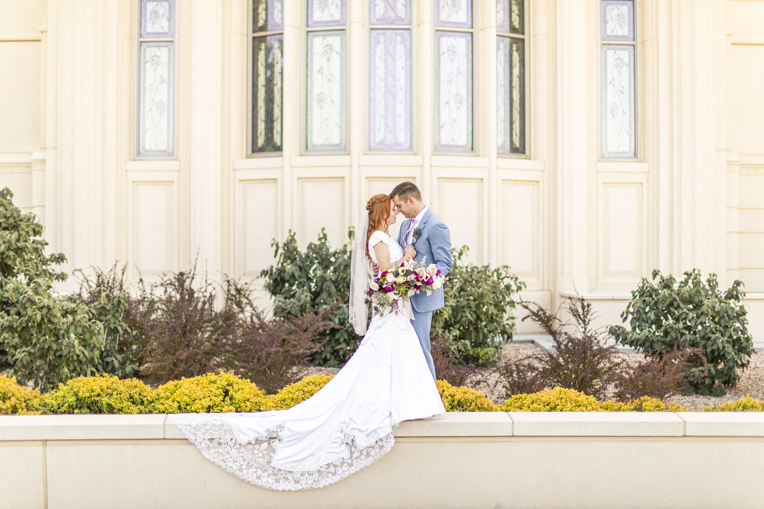  beautiful unique train wedding dress inspiration touching foreheads romantic wedding day photo shoot pose inspiration for utah brides payson temple professional utah photographer temple ground photo shoot inspiration summer wedding photo shoot inspi