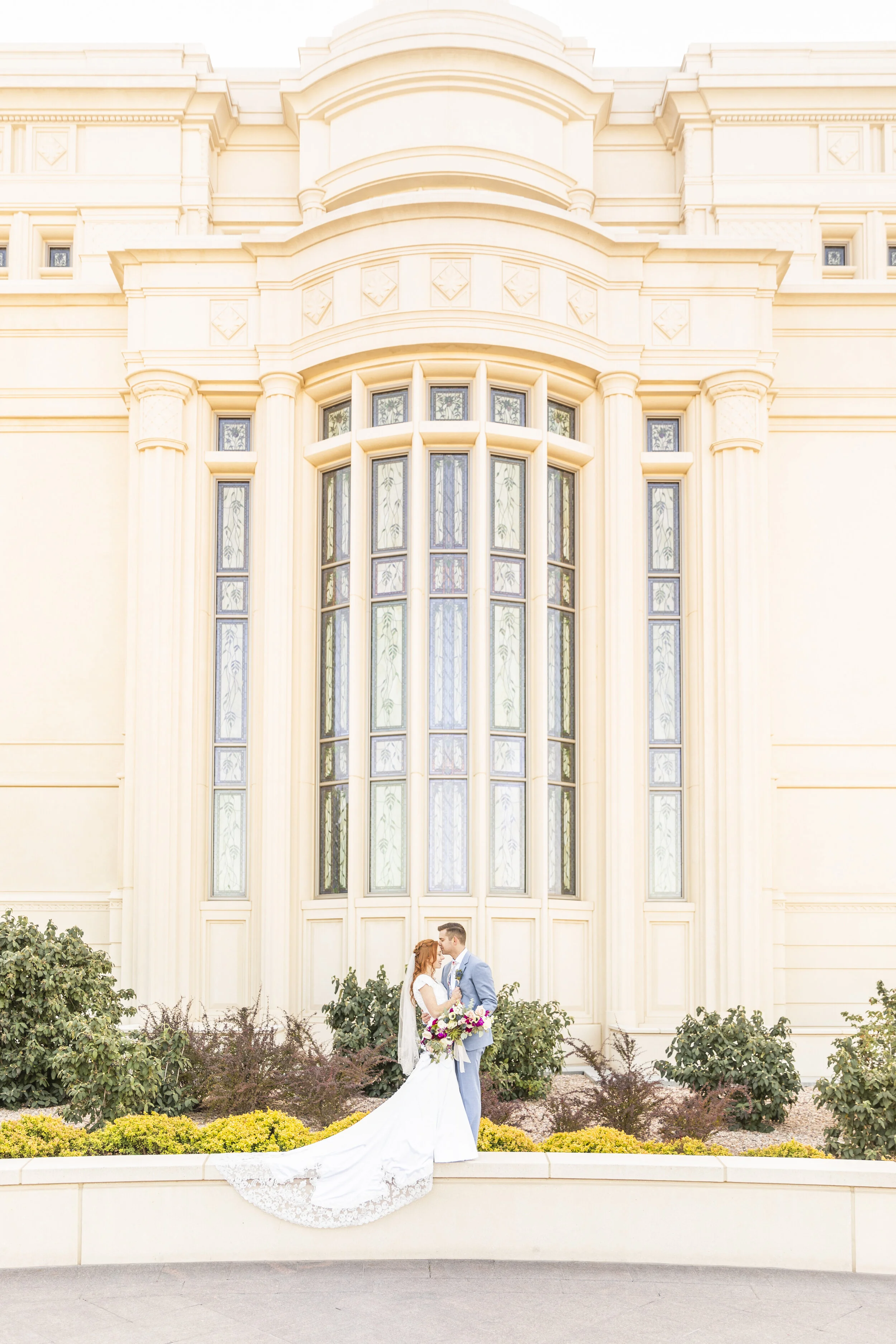  temple wall kiss on temple grounds wedding day couple pose inspiration church of jesus christ of latter day saints temple wedding inspiration utah temple happy couple couple goals couple in love beautiful location photo shoot lds temple grounds summ