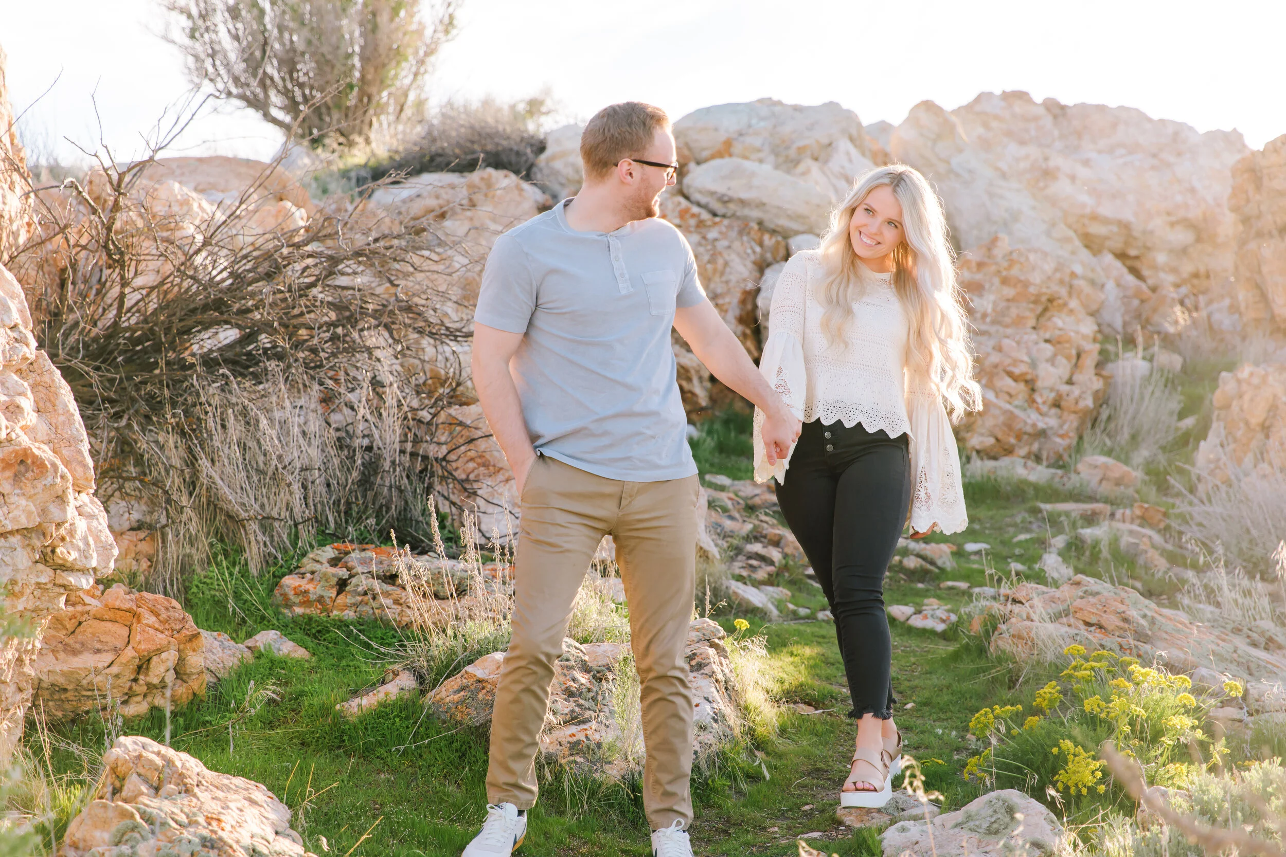  walking in the boulders antelope island photo shoot session utah photo shoot locations loving couple young love you can see the love in their eyes surrounded by nature interesting and unique photo shoot session and location warm and bright colors vi