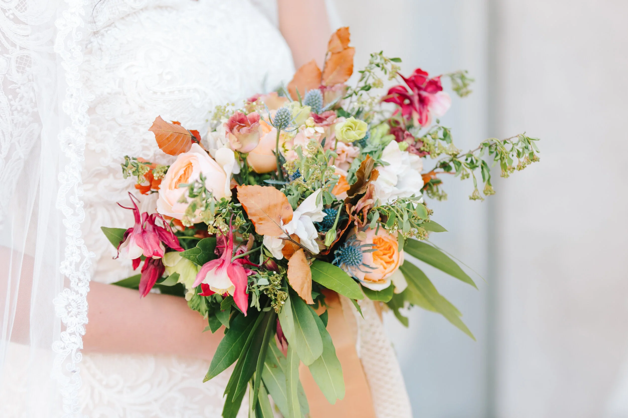  unique warm colored wedding bouquet inspiration close up on the bride and her bouquet inspiration beautiful close up bridal aesthetic inspiration lace wedding dress and lace wedding veil wedding attire inspiration goals ideas and more wedding flower