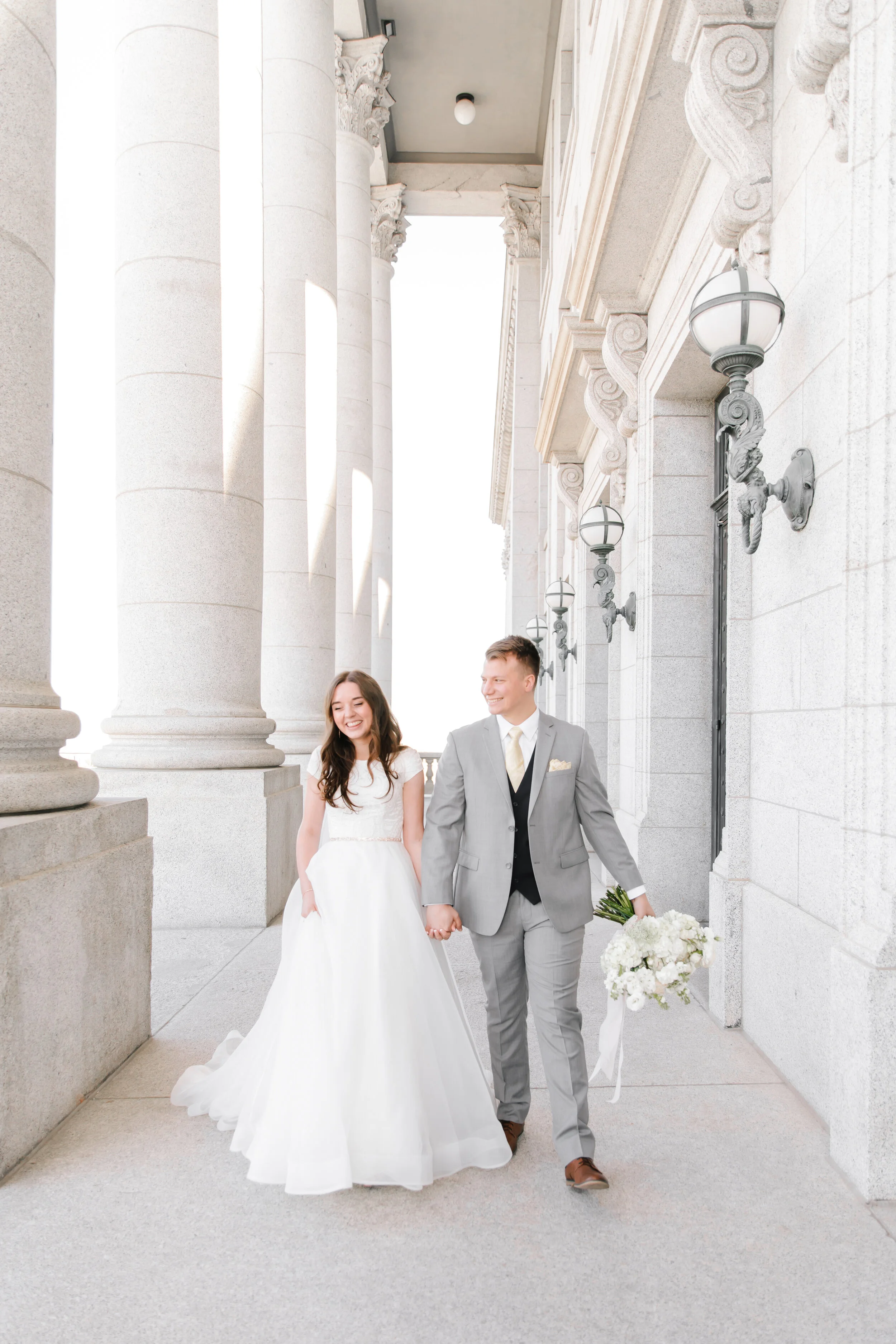  walking outside the capital building beautiful romantic wedding photo shoot location utah wedding photo shoot goals and inspiration beautiful couple  wedding attire inspiration for lds brides modest wedding dress inspiration groom attire wedding uta