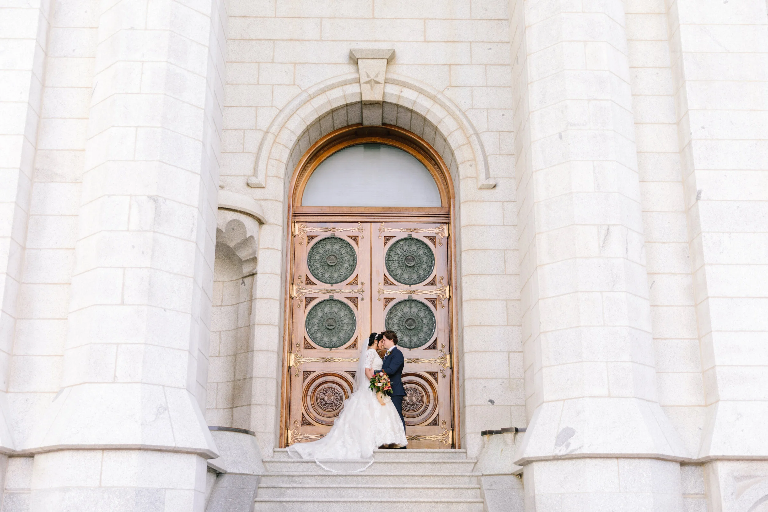  kiss at the top of the salt lake city steps getting married in the temple temple wedding goals mormon goals beautiful doors wedding day picture pose inspiration profession utah photographer clarity lane professional photographer gorgeous temple salt