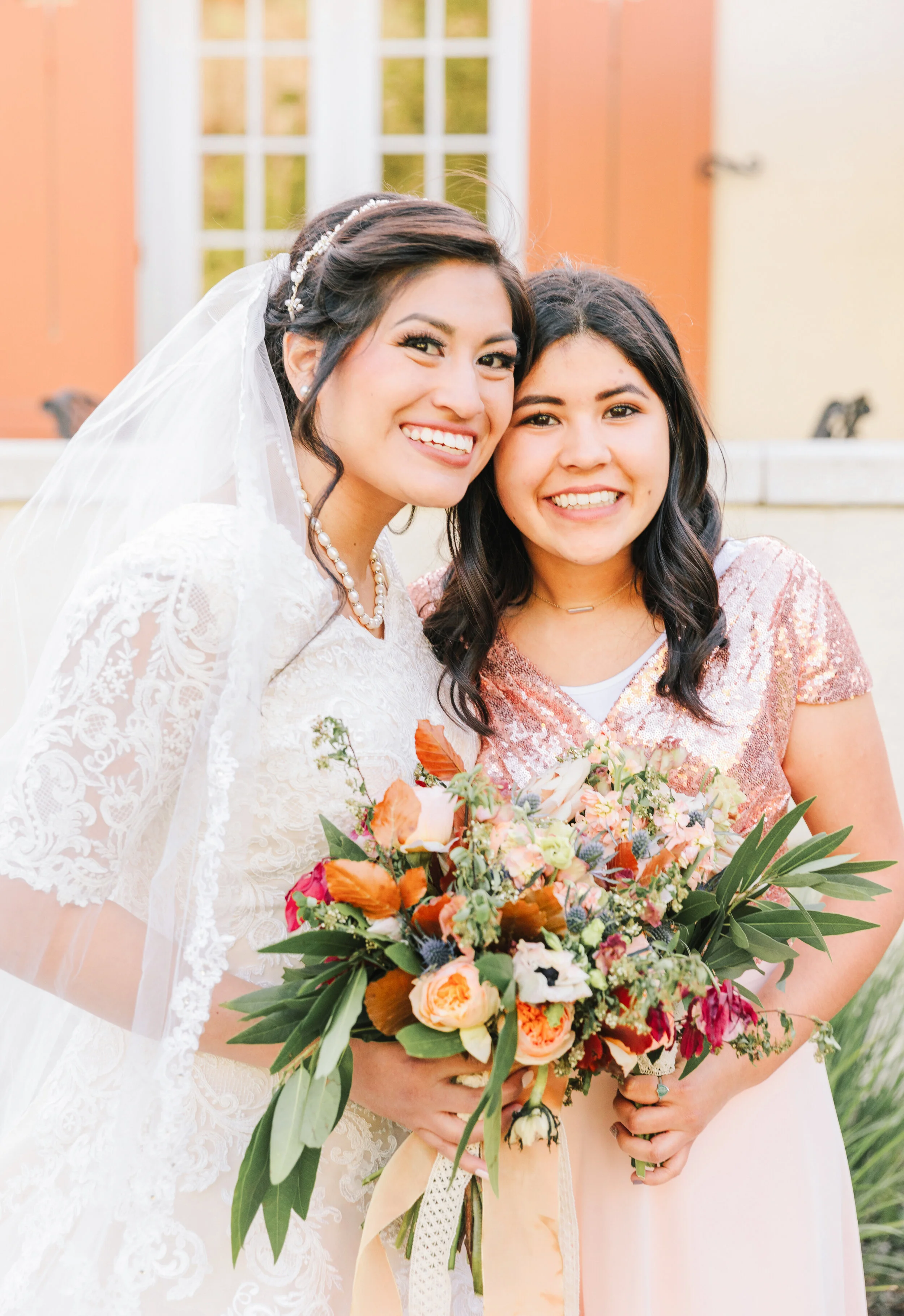  bride with the bridesmaid modest bridesmaids dress peach bridesmaids dress wedding dress inspiration lace wedding dress long wedding veil wedding attire wedding accessories wedding necklace inspiration pearl necklace wedding hairstyle inspiration be