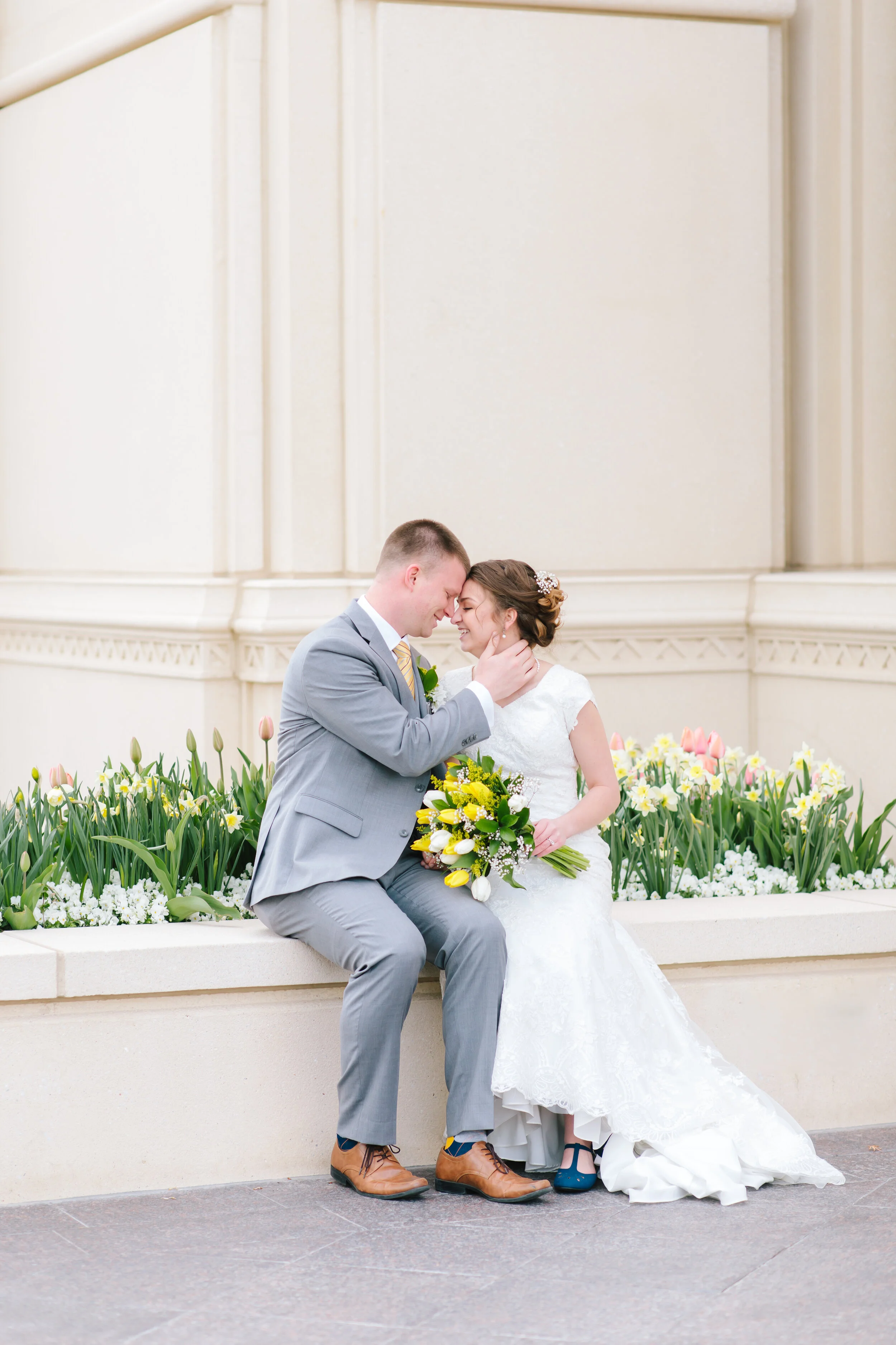  sweet romantic moment shared between husband and wife newly wed pose inspiration couple pose inspiration couple goals life goals sitting on the temple wall together pose inspiration bridal photo shoot formal wedding photo shoot inspiration utah #wed