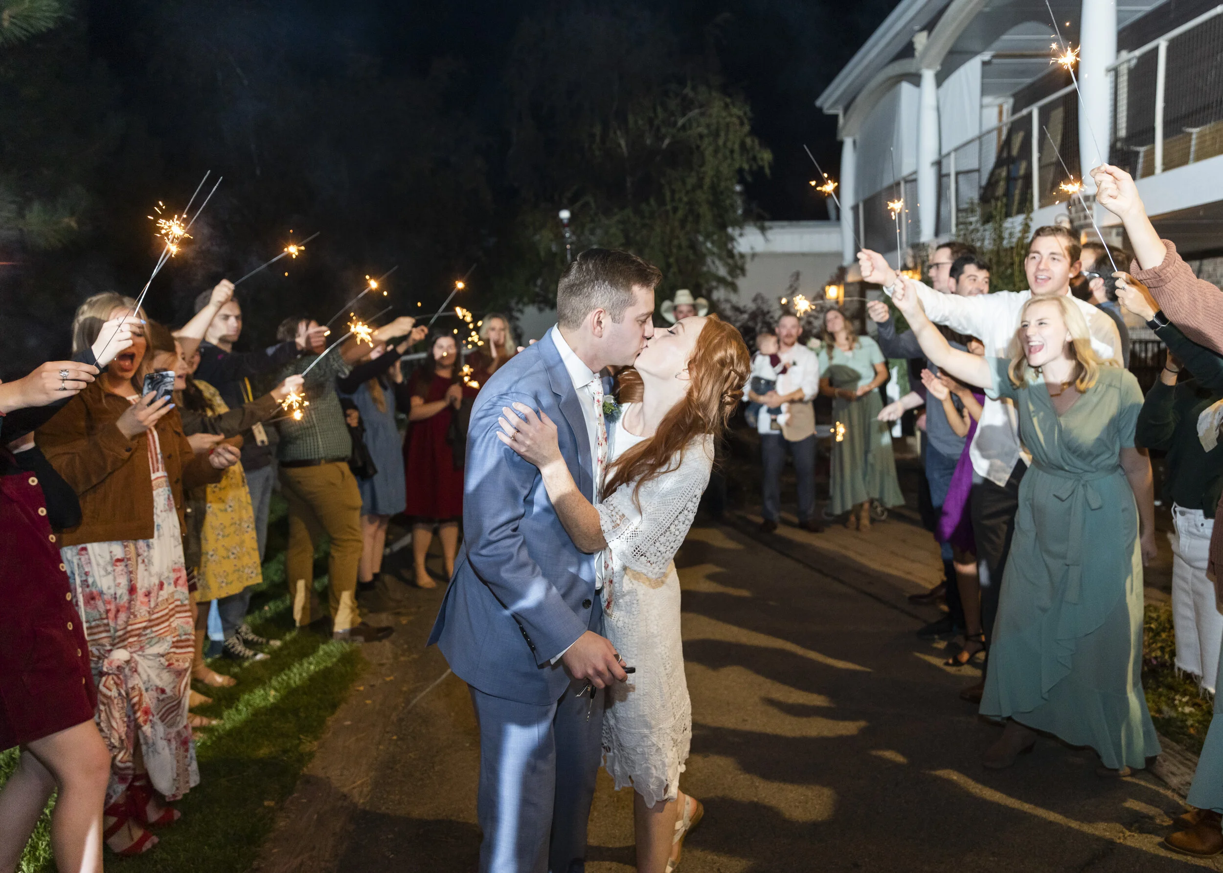  wedding reception send off kiss before they leave summer night send off for the newly weds night time photography inspiration wedding reception send off inspiration goals and ideas for utah brides modern bride reception inspiration ideas goals and i
