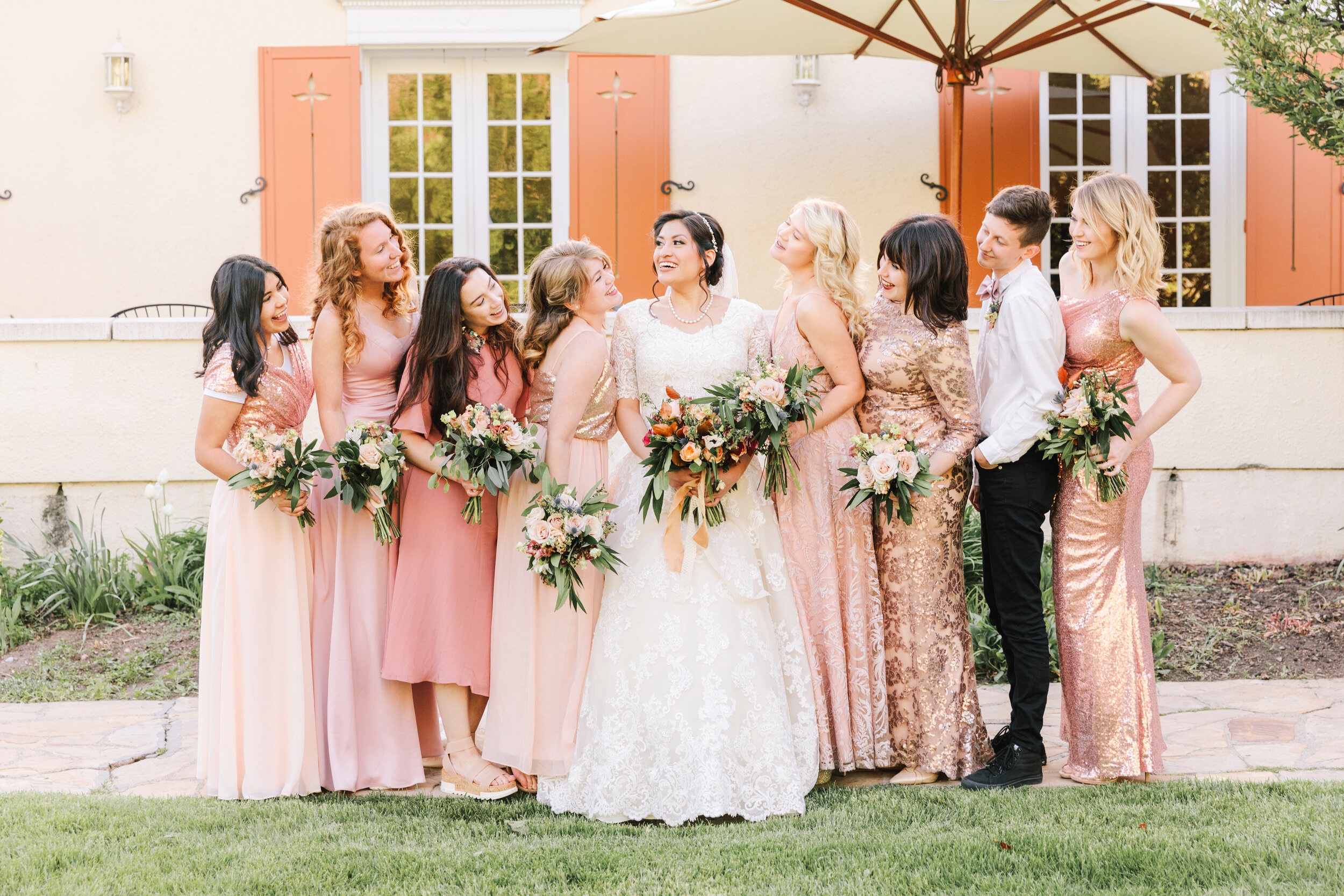  bride and her bridesmaids bridal wedding party bridesmaids wedding dress inspiration wedding attire inspiration bridesmaids dresses that are all a little different warm pink bridesmaids dresses beautiful unique wedding party attire inspiration warm 