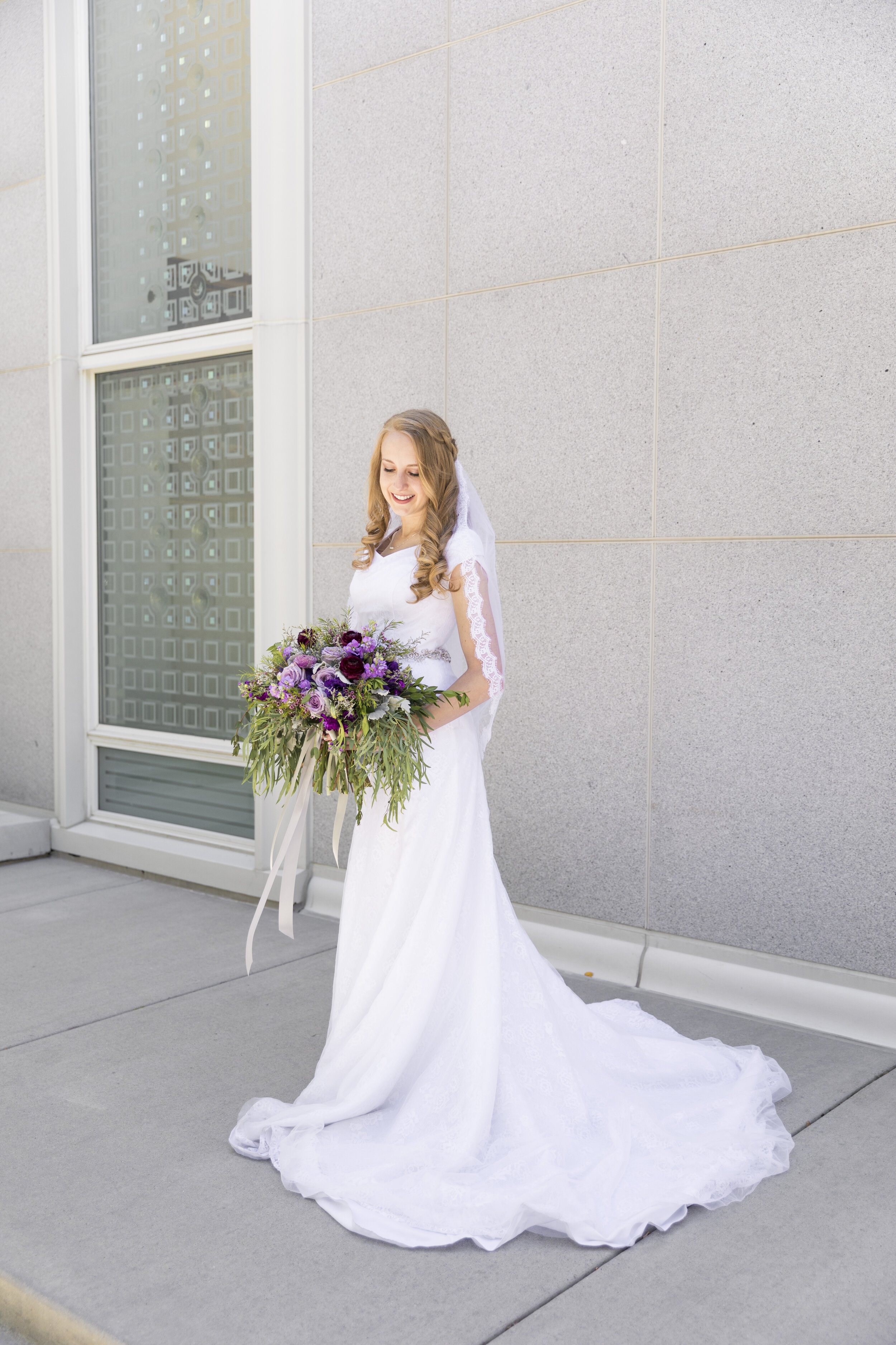  just the bride in front of the temple bridal photo shoot inspiration bridal pose inspiration purple bouquet inspiration wedding bouquet inspiration ideas and goals for the modern bride summer wedding dress inspiration modest wedding dress goals  #we