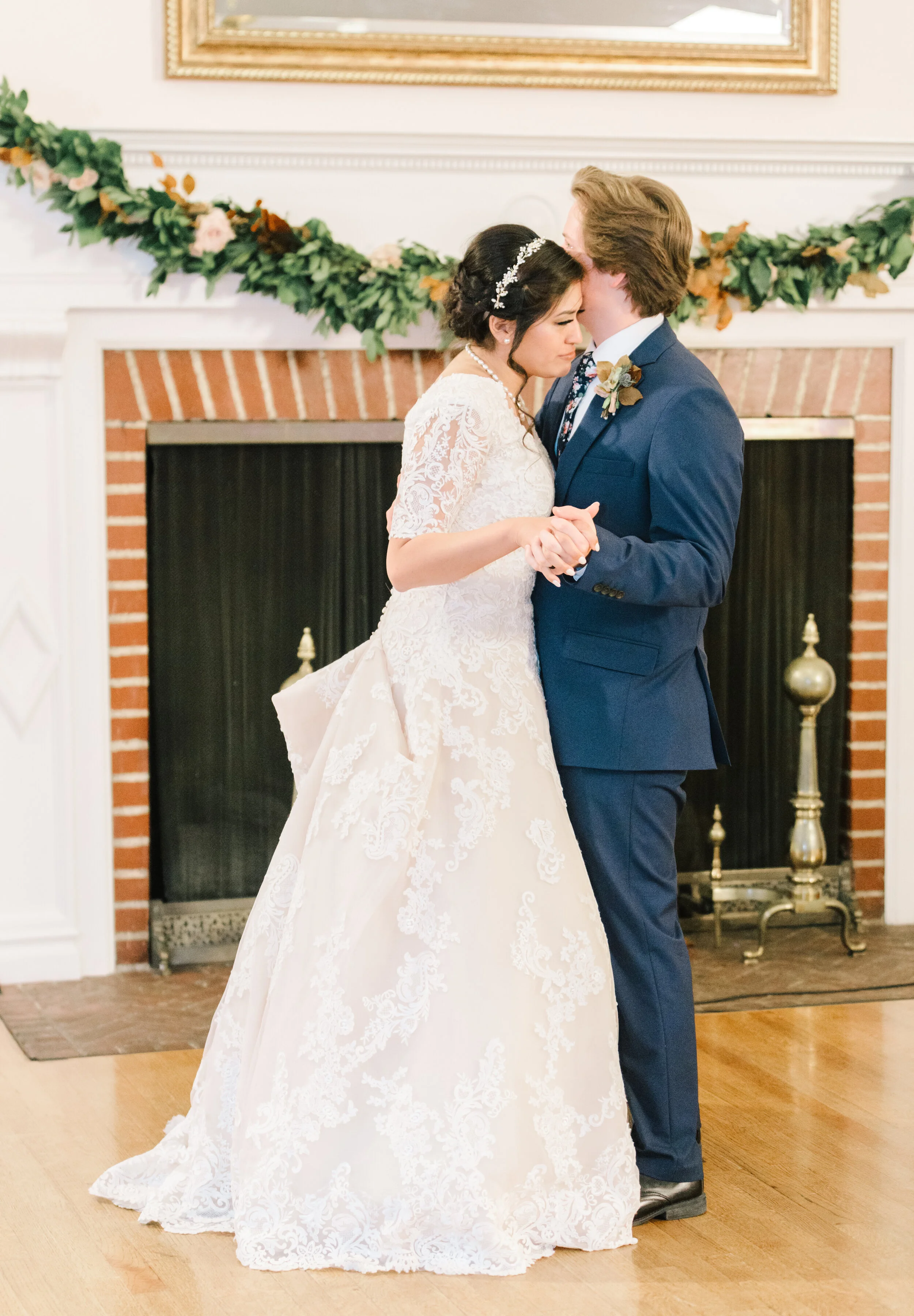  fist dance together as husband and wife wedding day garland inspiration warm toned wedding garland flowers loving moment ready to spend eternity together starting eternity off right wedding dress inspiration goals and ideas for modern utah brides pe