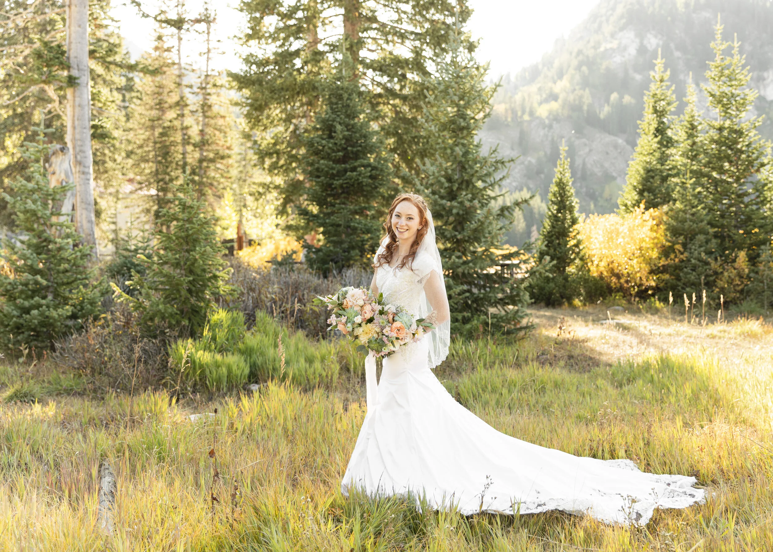  Gorgeous fall canyon bridal portrait nature forest bridals beautiful bride holding large bouquet blush roses red hair wedding hairstyle flowing train wedding gown homemade wedding dress bride only wedding photo beautiful background bridals print wor