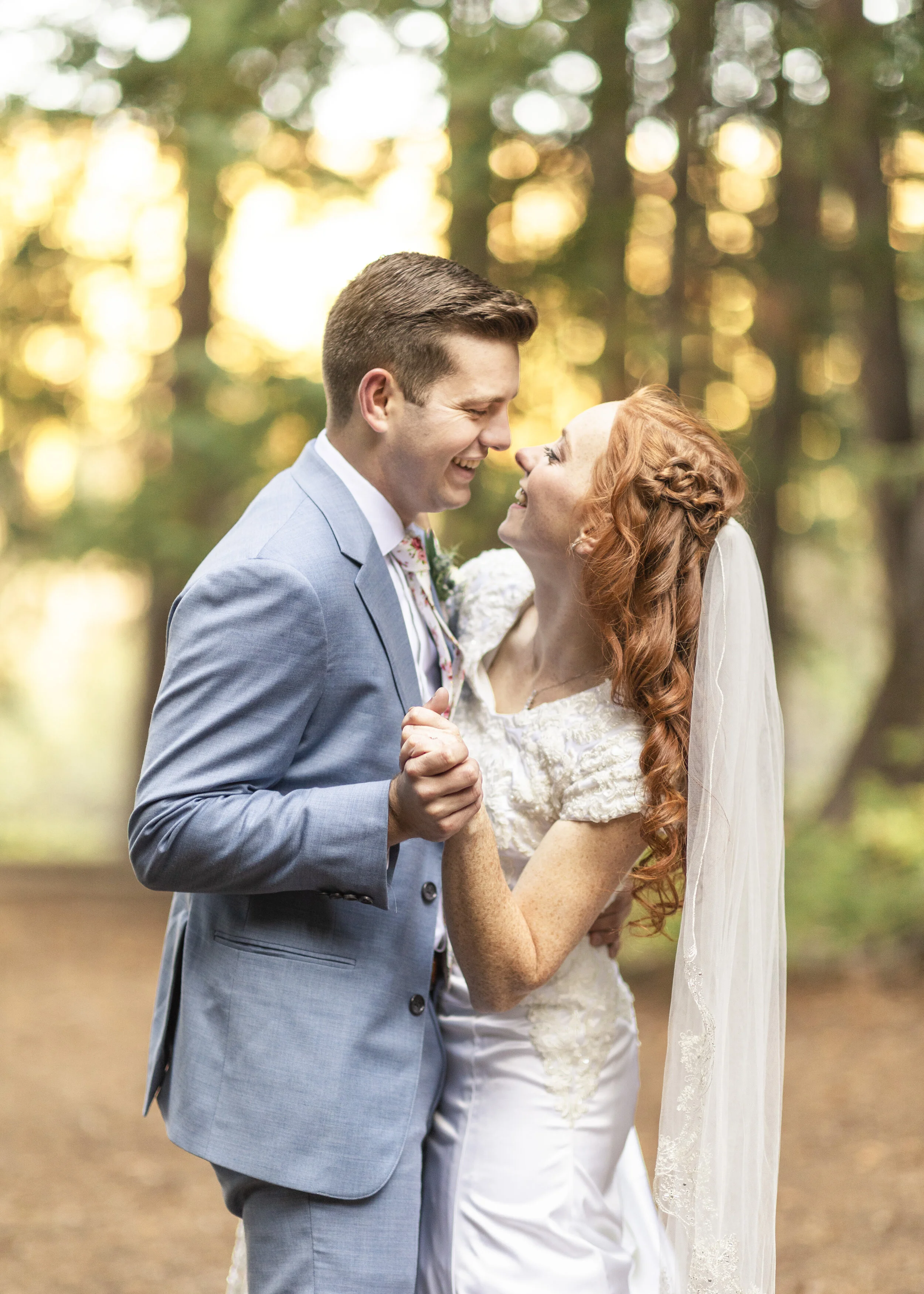  Sweet bride and groom dancing together dancing pose authentic smiles authentic wedding photos bride hairstyle inspo unique hairstyles wedding day loose curls red haired bride half updo happy couple blurry background shoot gorgeous lighting fall brid