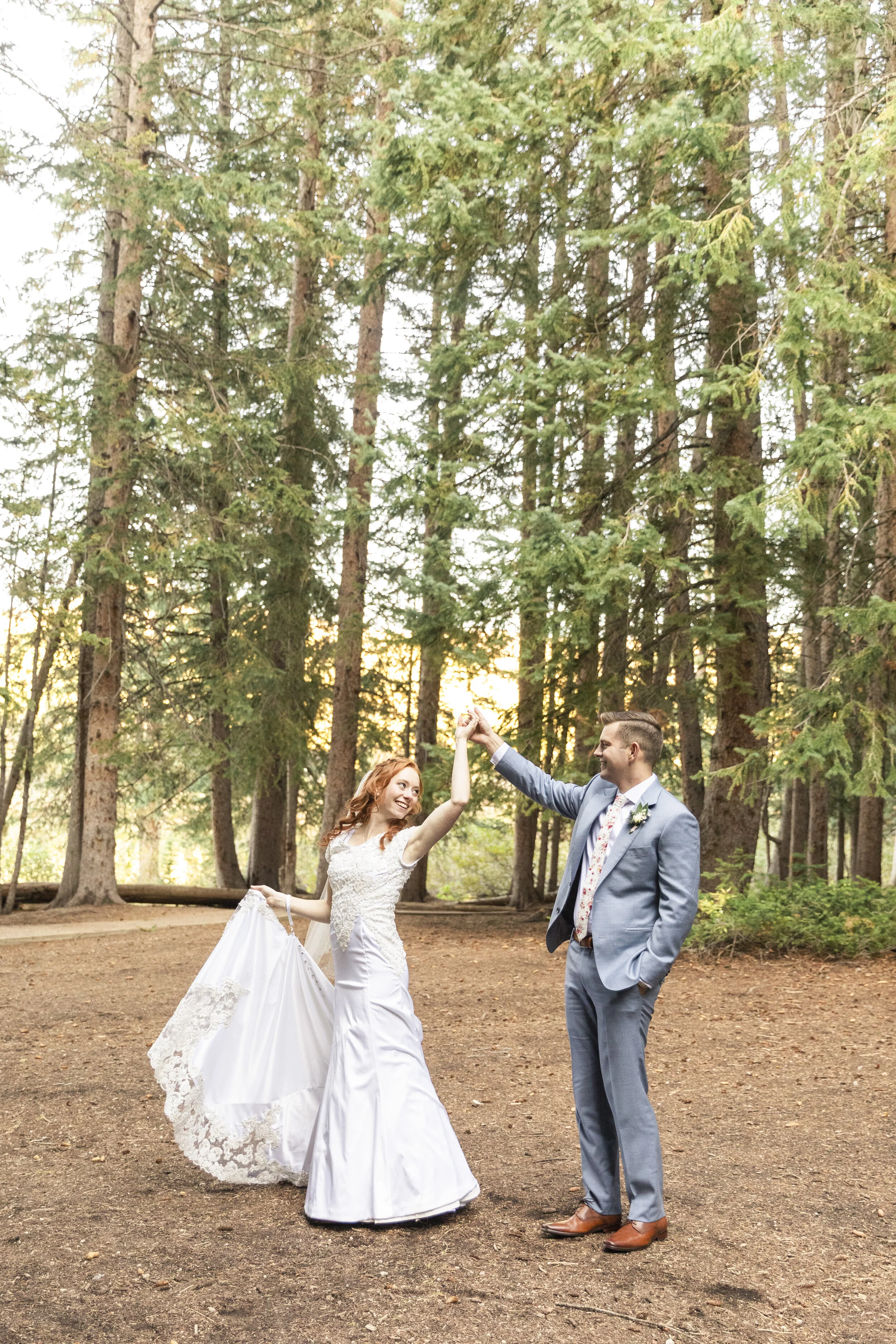  Proud groom spinning his new bride forest background golden hour lighting sunset lighting inspiration beautiful wedding gown homemade wedding dress lace train happy couple wedding dance what to do with hands in wedding photos bridal pose inspiration