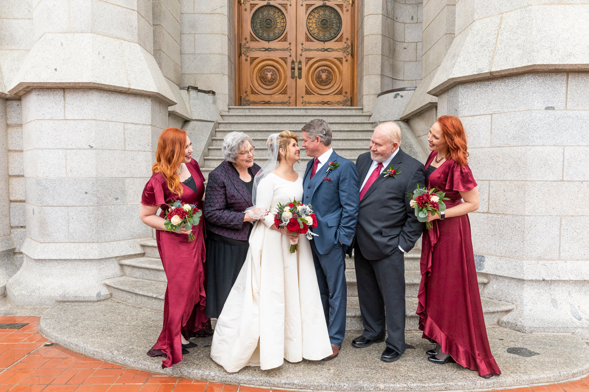  salt lake city lds temple wedding just married family photos cranberry red and navy wedding colors temple steps and doors rainy wedding day professional utah valley wedding photographer temple square #saltlakeldstemple #saltlakecityutah #templesquar