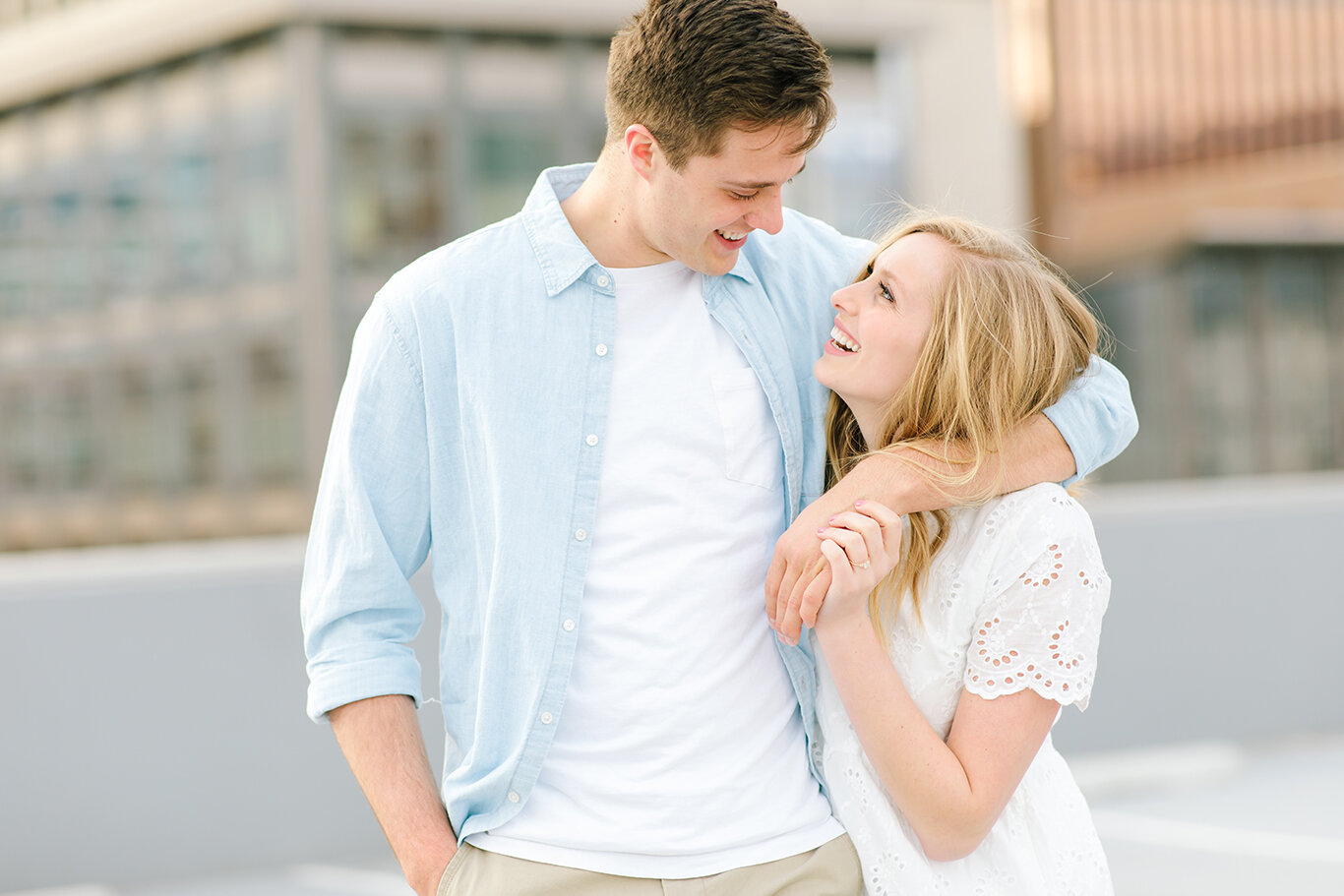  arm around fiance engagement photo session downtown photo session cityscape city creek mall harmon’s building rooftop photo session salt lake city utah professional utah valley engagement photographer #downtownsaltlakecity #engagements #utah #saltla