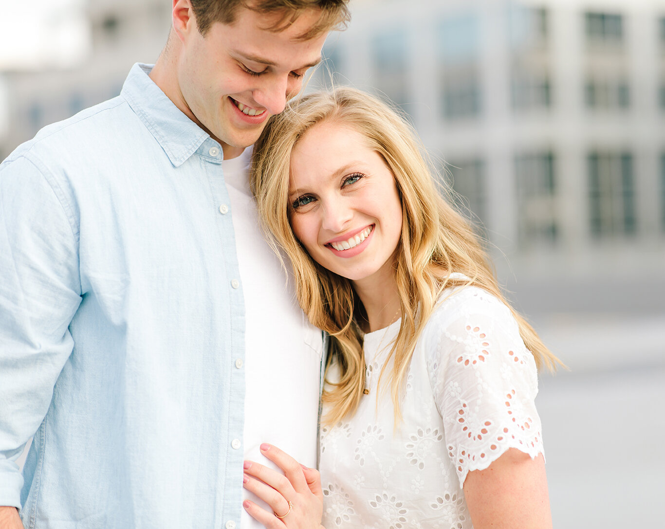  cityscape downtown engagement photo session city creek mall harmon’s building rooftop photo shoot light blue collared shirt white lace short sleeve dress loose hanging curls salt lake city utah professional utah valley engagement photographer #downt