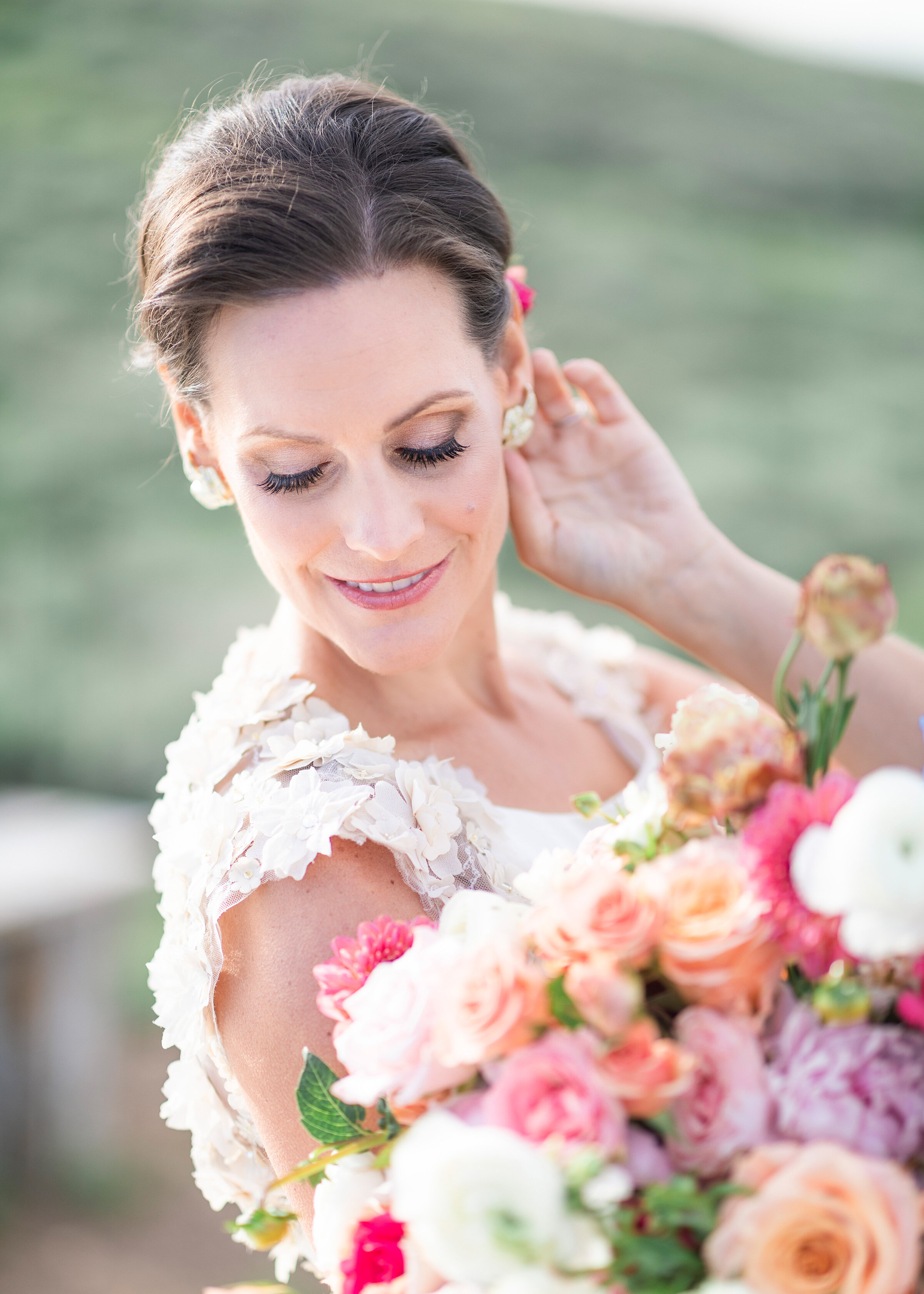  A feminine look equipped with floral accents for this picture perfect Utah Valley bridal shoot by Clarity Lane in the mountains. floral wedding dress lash extensions diamond wedding earrings bridal accessories pink purple orange pastel rose bridal b