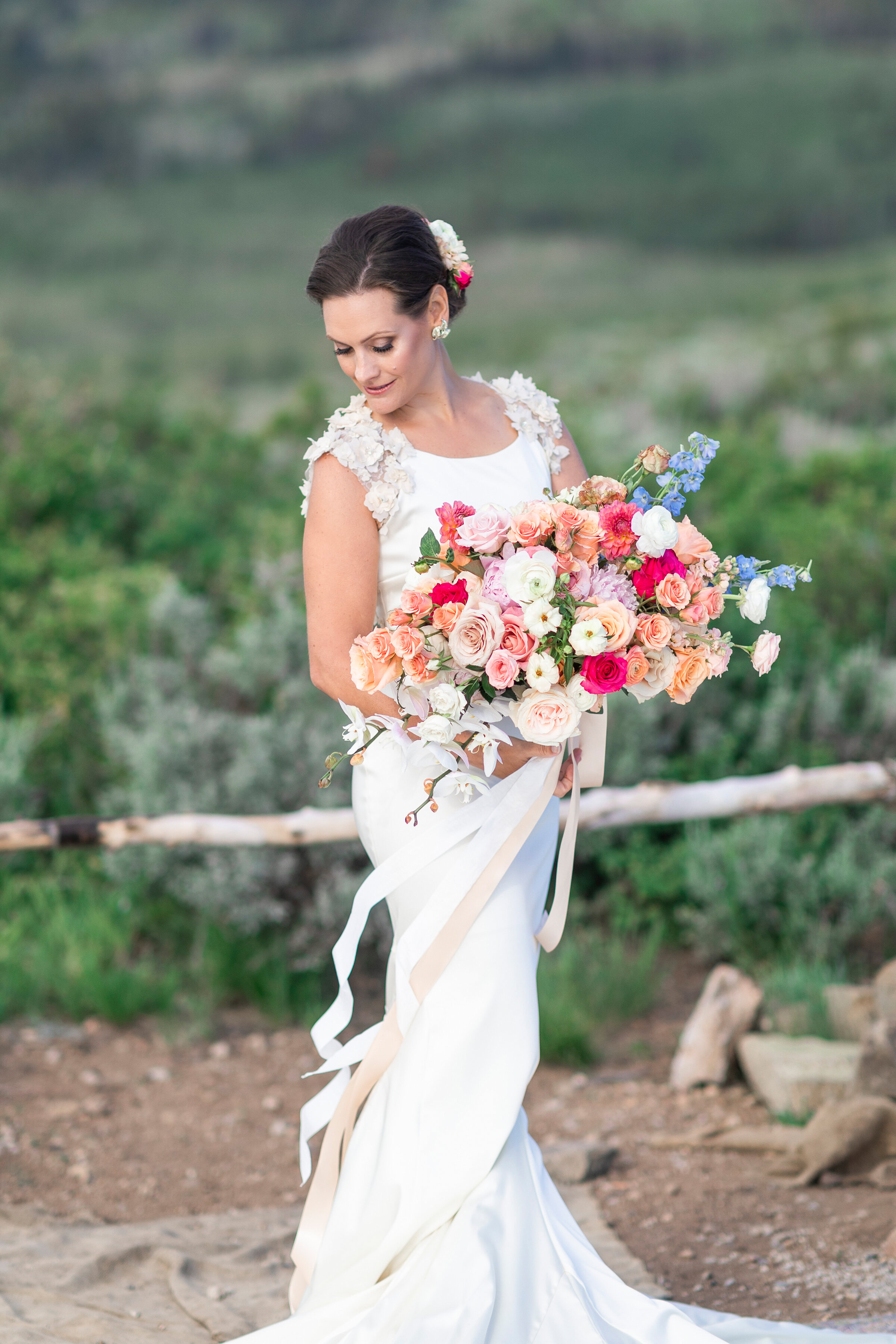  stunning feminine bridals shot by clarity lane photography with a lush green mountain backdrop in utah valley. pastel pink orange peach rose bridal bouquet profile photography utah valley mountains salt lake city utah wedding photographer floral wed