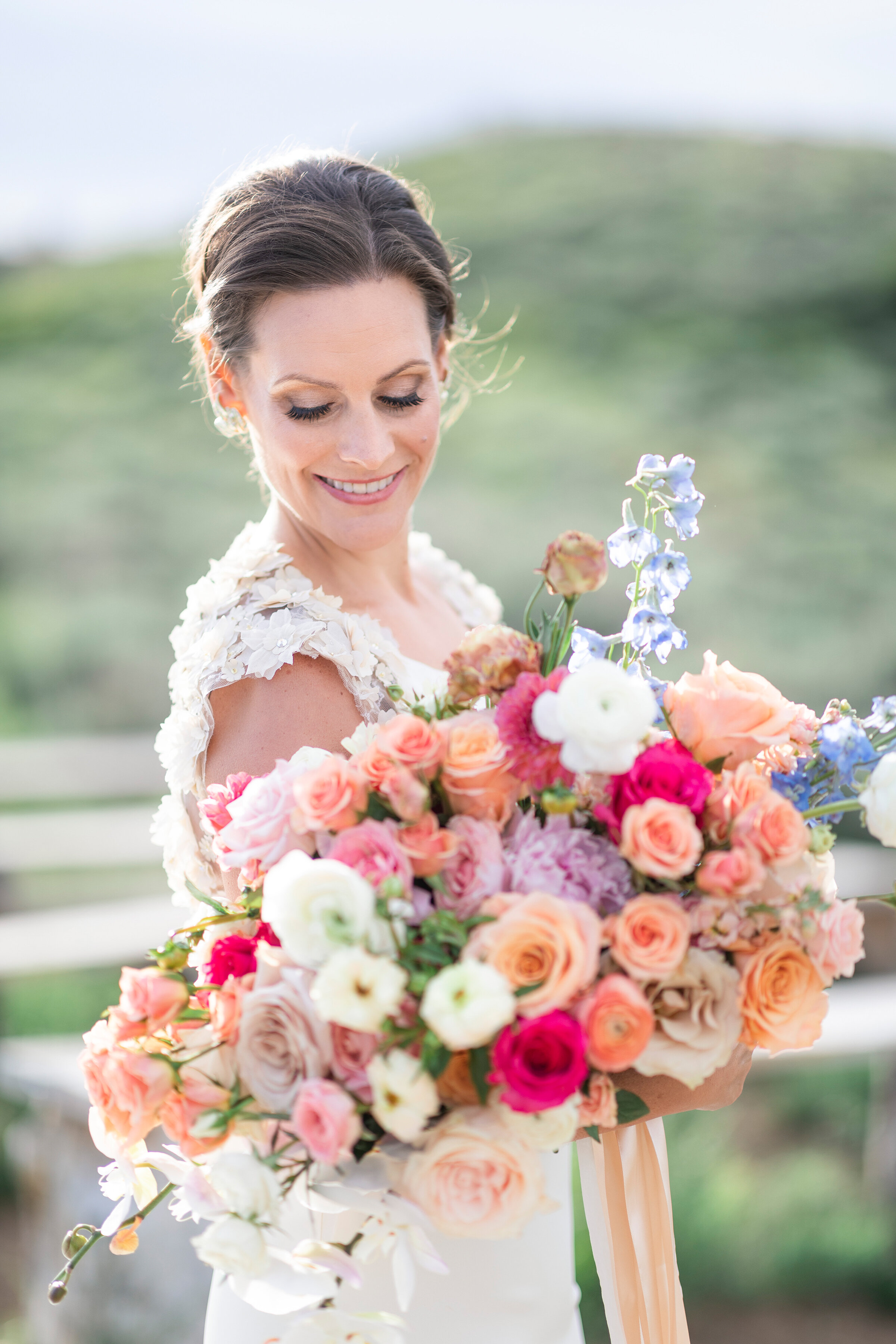  utah mountain bridal shoot featuring a pastel wedding bouquet and accented wedding dress by clarity lane photography in salt lake city utah. pastel pink, peach, white wedding bouquet, flower wedding dress sleeves green mountain background wooden fen