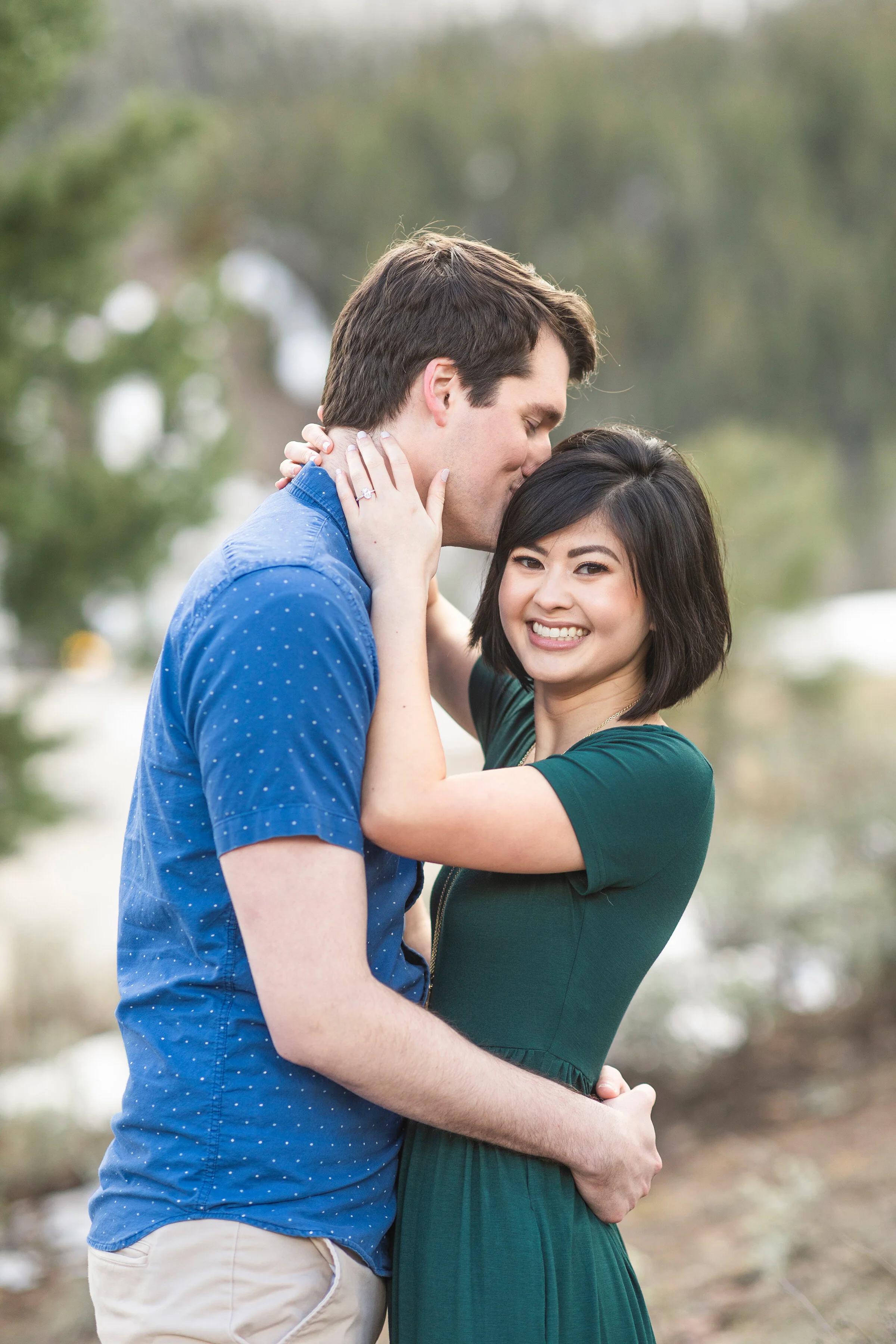  Newly weds holding each other in the snowy mountains in a winter styled photo shoot by Clarity Lane. Winter photo shoot inspiration ideas and goals couple goals couple pose inspiration short sleeved winter outfit inspiration ideas and goals newly we