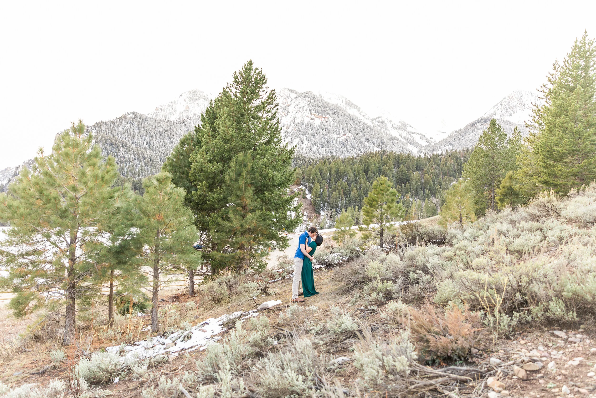  A sweet couple kissing in the distance in a newly wed photo shoot by Clarity Lane. Photography goals winter photo shoot inspiration ideas and goals couple goals winter goals advice for newly wed brides foggy winter photo shoot inspiration ideas and 