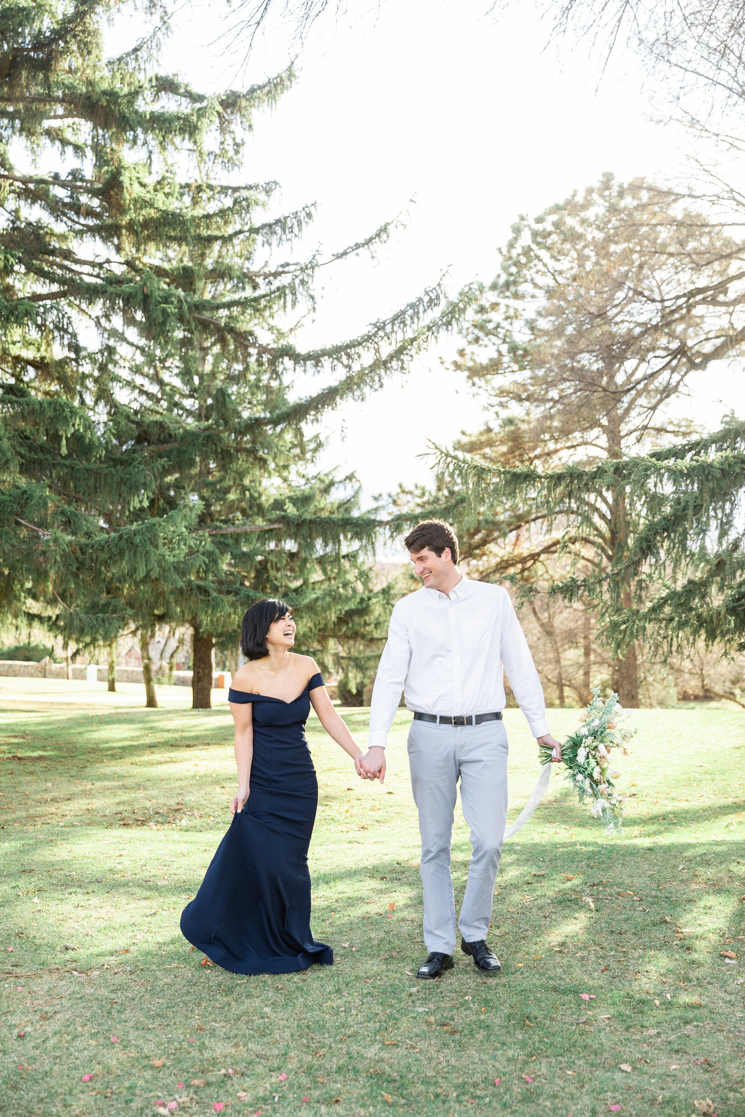  A beautiful couple walking together through the trees on a bright winters day in a romantic newly wed styled photo shoot by Clarity Lane.  Formal photo shoot attire inspiration photo shoot goals couple goals photography goals winter photo shoot insp