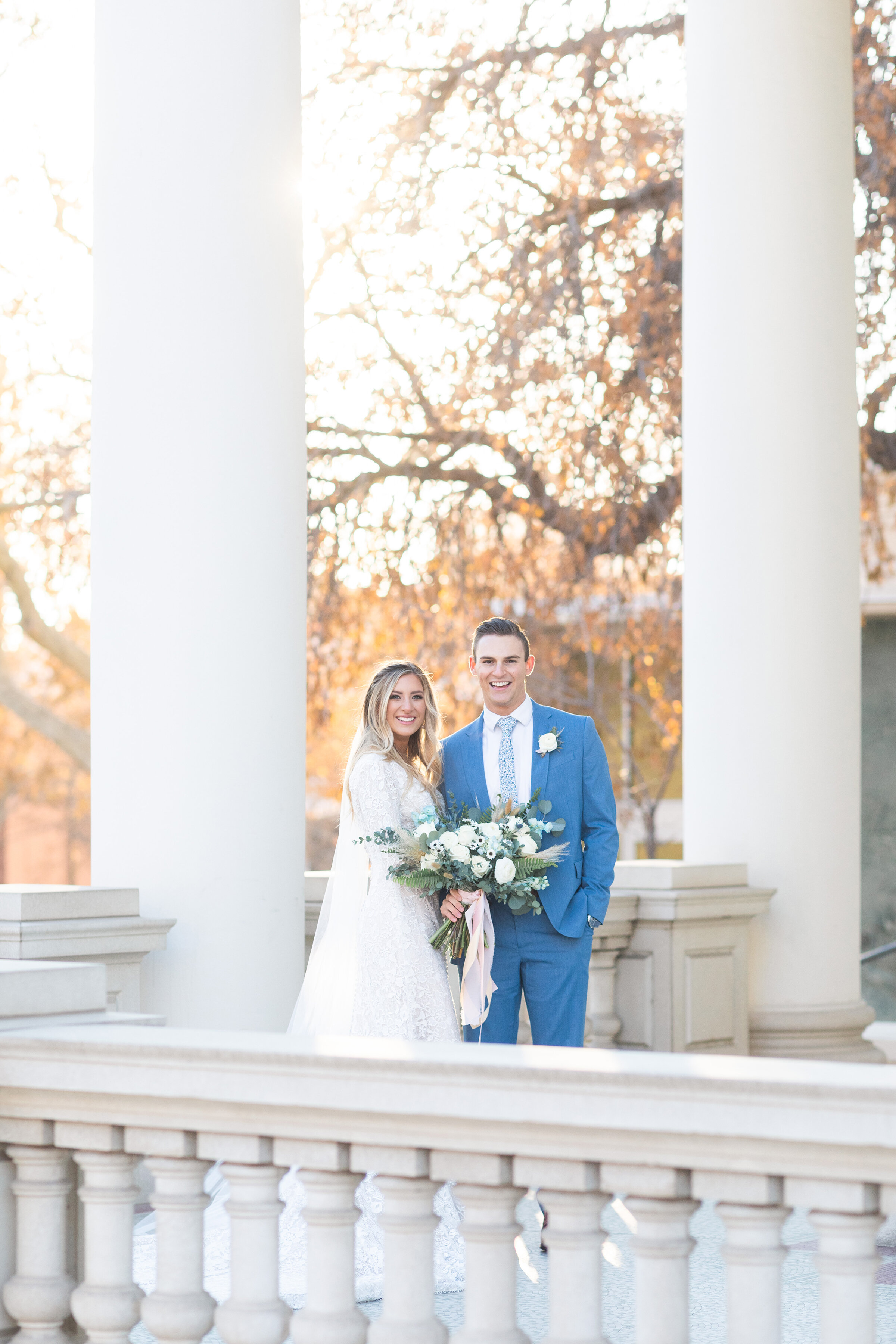  Surrounded by stone pillars and balconies, this bride and groom pose for Clarity Lane Photography outside the Monson Center in Salt Lake City, Utah. salt lake city utah architecture, urban wedding photos, professional salt lake county wedding photog