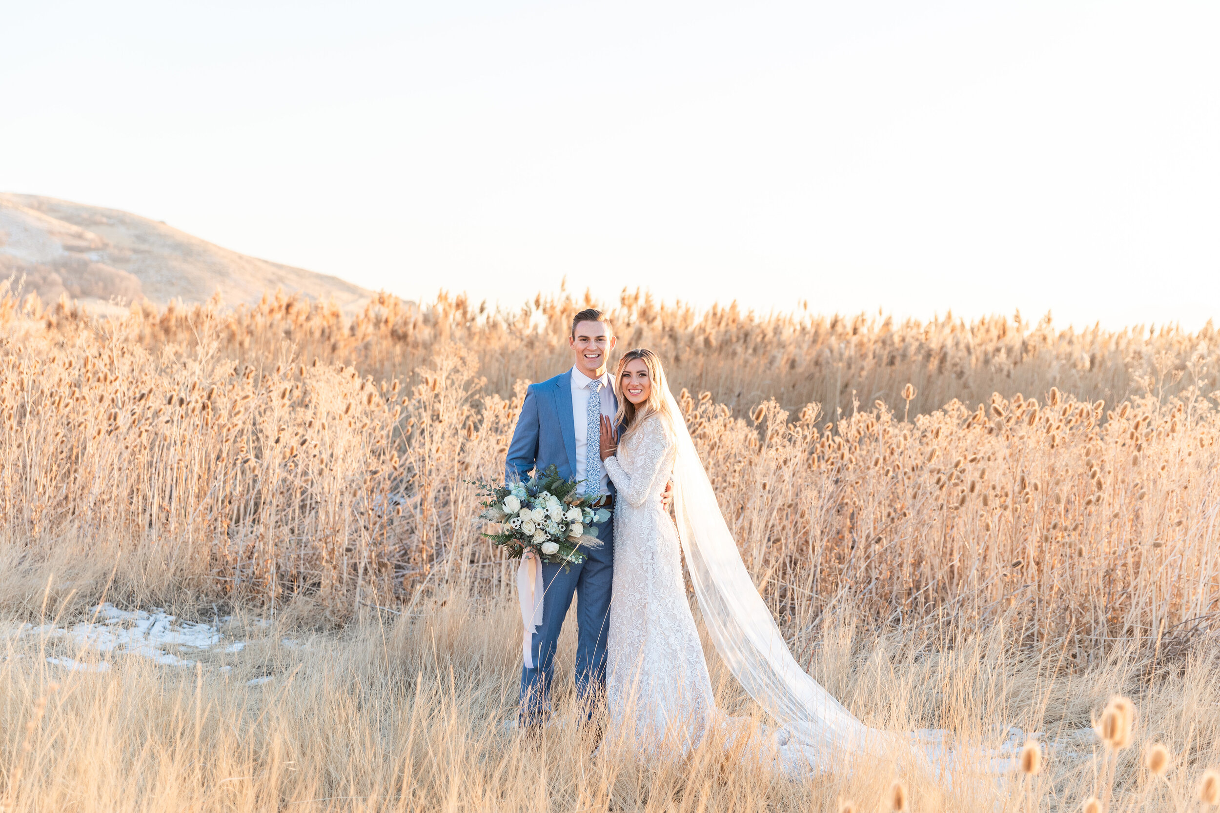  Posed amongst rolling utah hills and tall grass, this bridal session shot by Clarity Lane Photography in Salt Lake City, Utah is filled with romance. tall dried grass bridal session, professional salt lake city utah wedding photographer, tunnel spri