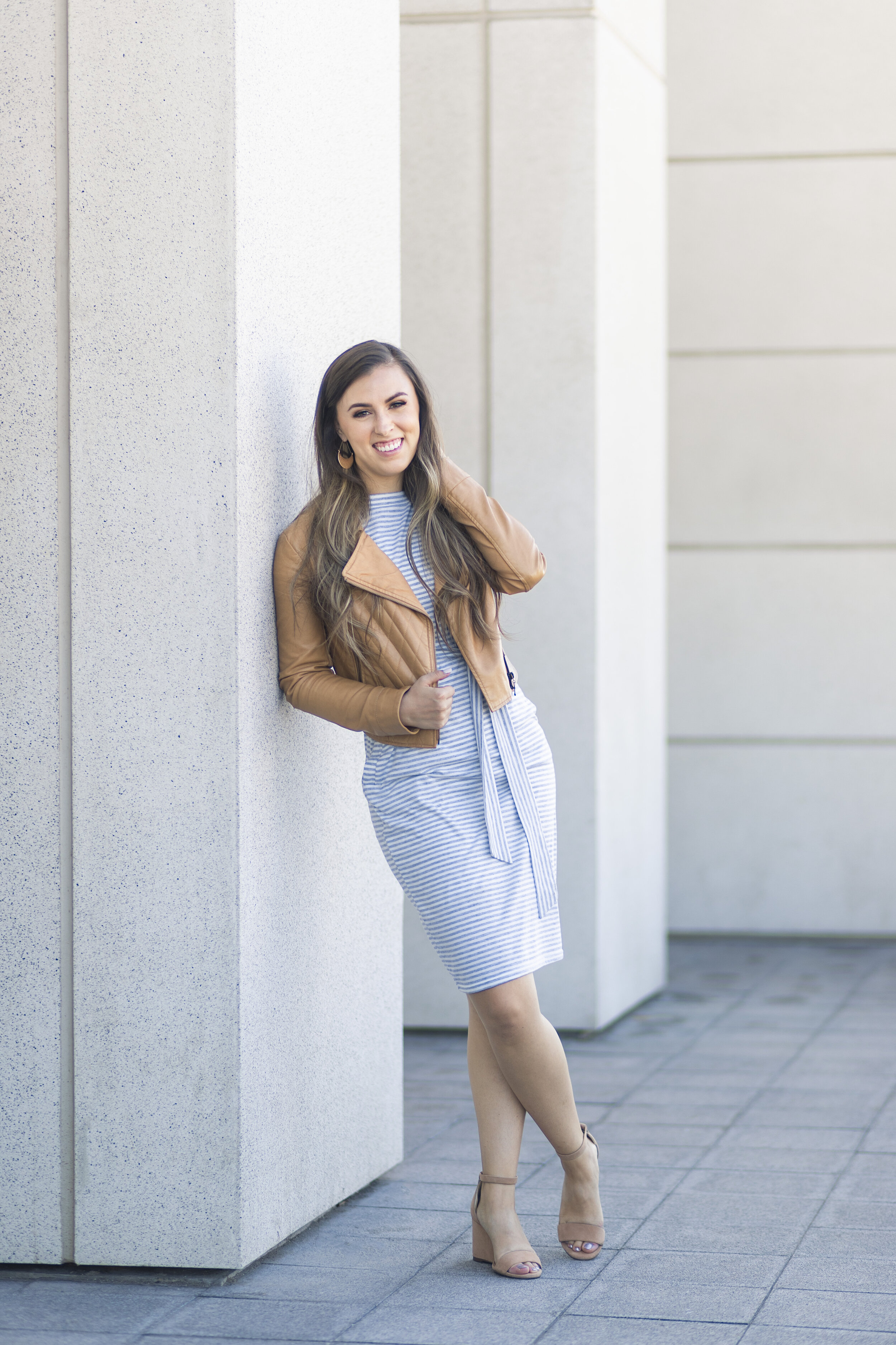  Posed near a cement building in Salt Lake, Utah,, Savanna from Utah Valley’s Clarity Lane Photography shares details about branding photoshoots. leather womens jacket, nude wedge pumps, professional utah valley photographer, brand photoshoot, profes