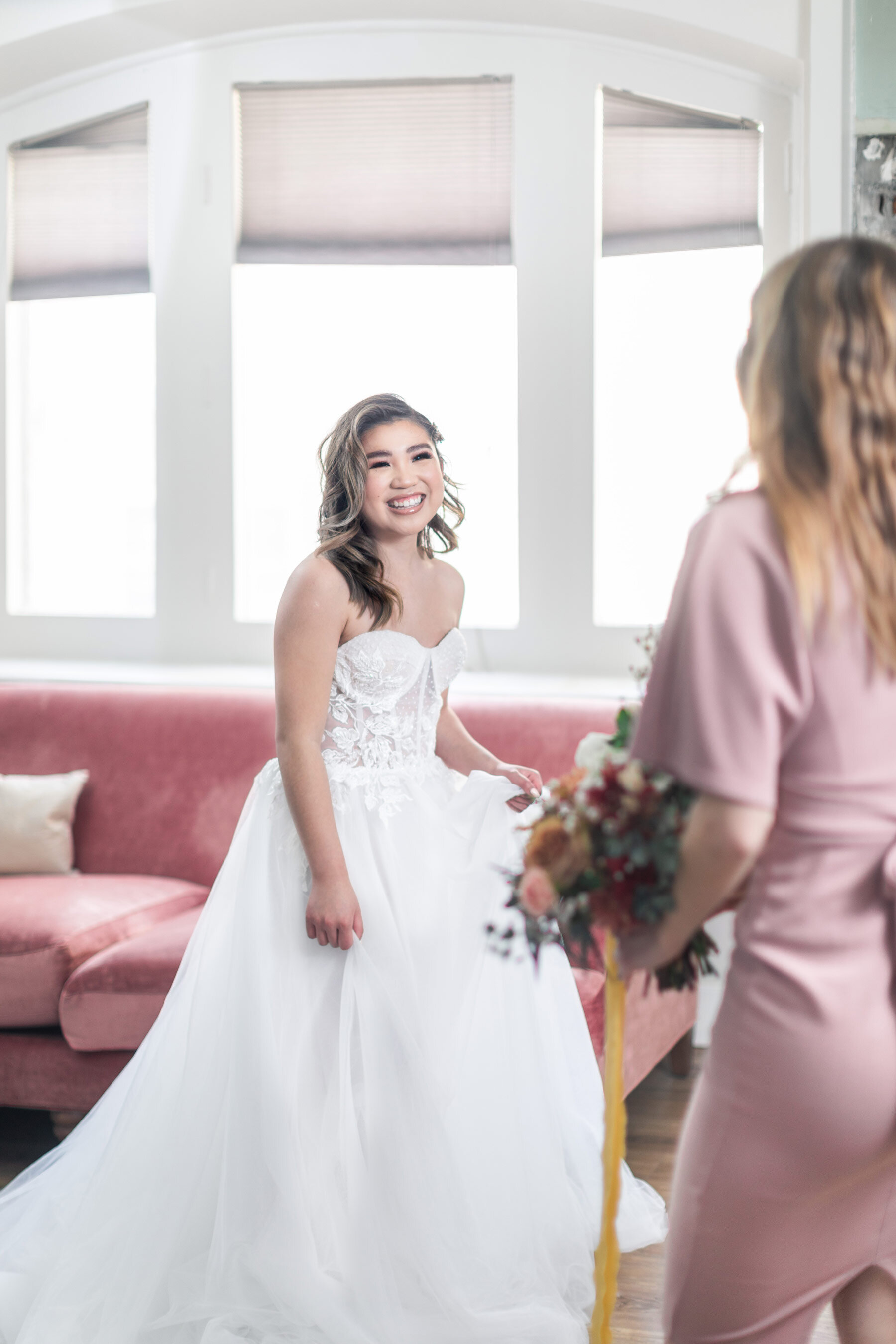  On this bride's wedding morning in Salt Lake City, UT, Clarity Lane captures silk robed bridesmaid's first looks as they see the bride in her wedding dress. translucent corset wedding dress strapless mauve silk bridesmaids robes Salt Lake City weddi