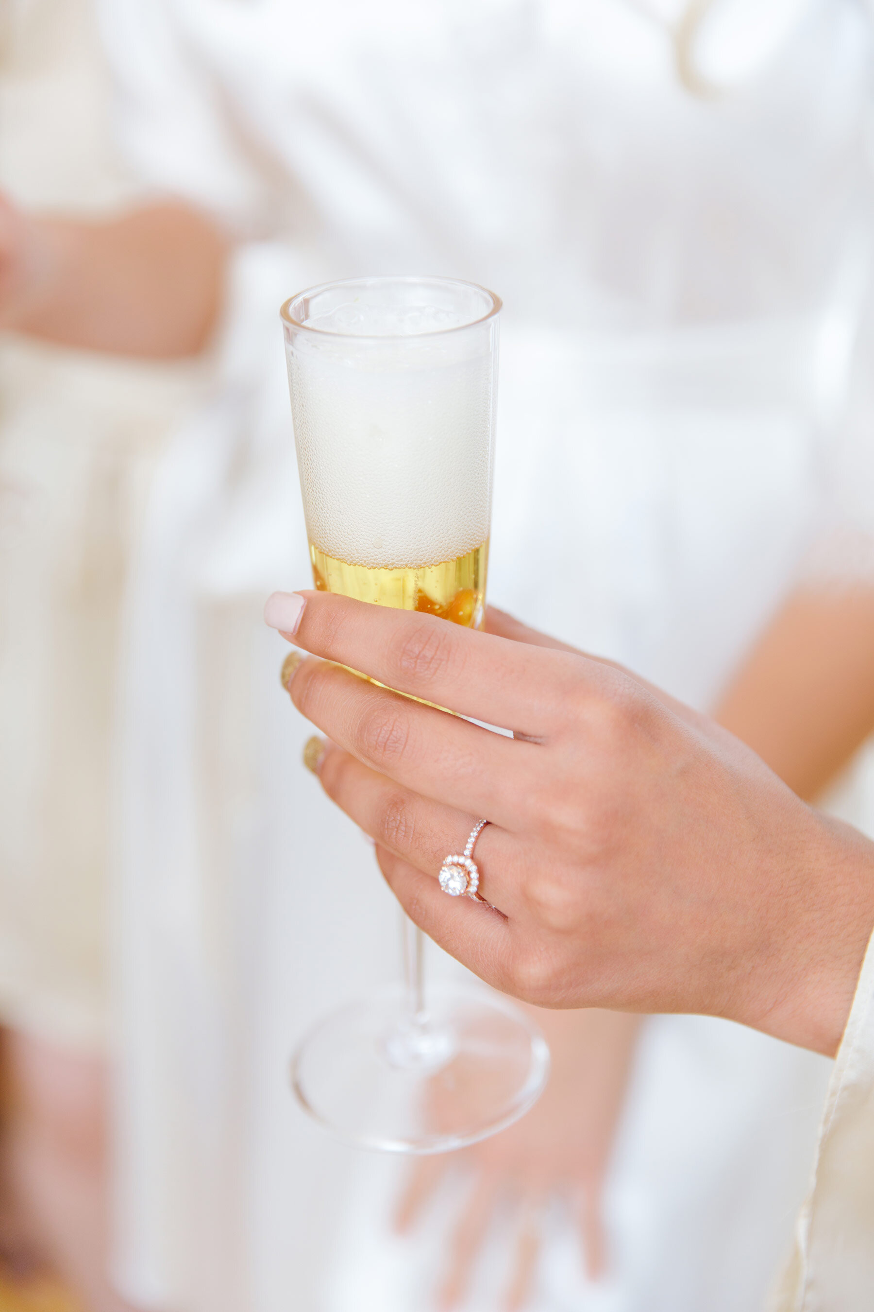  Utah County wedding photographer, Clarity Lane captures this bride holding a champagne glass on her wedding morning. wedding morning glass women's wedding nails silk brides robe Utah county wedding photographer women's white gold halo wedding ring #