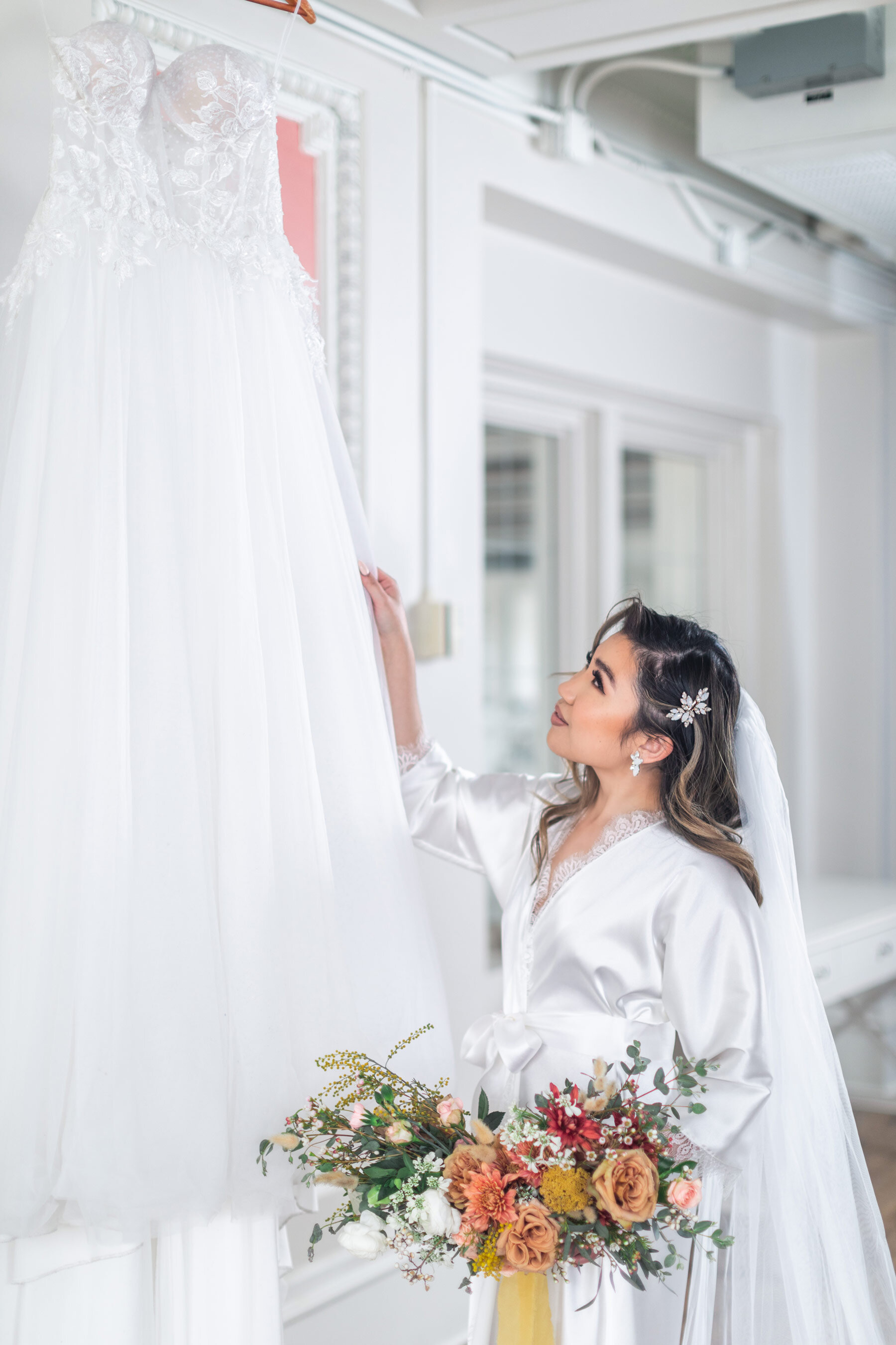  Utah County wedding photographer, Clarity Lane captures this bride on her wedding morning staring up at her wedding dress. strapless corset lace wedding dress bride on wedding morning in silk robe Utah county wedding photographer #ClarityLane #Weddi