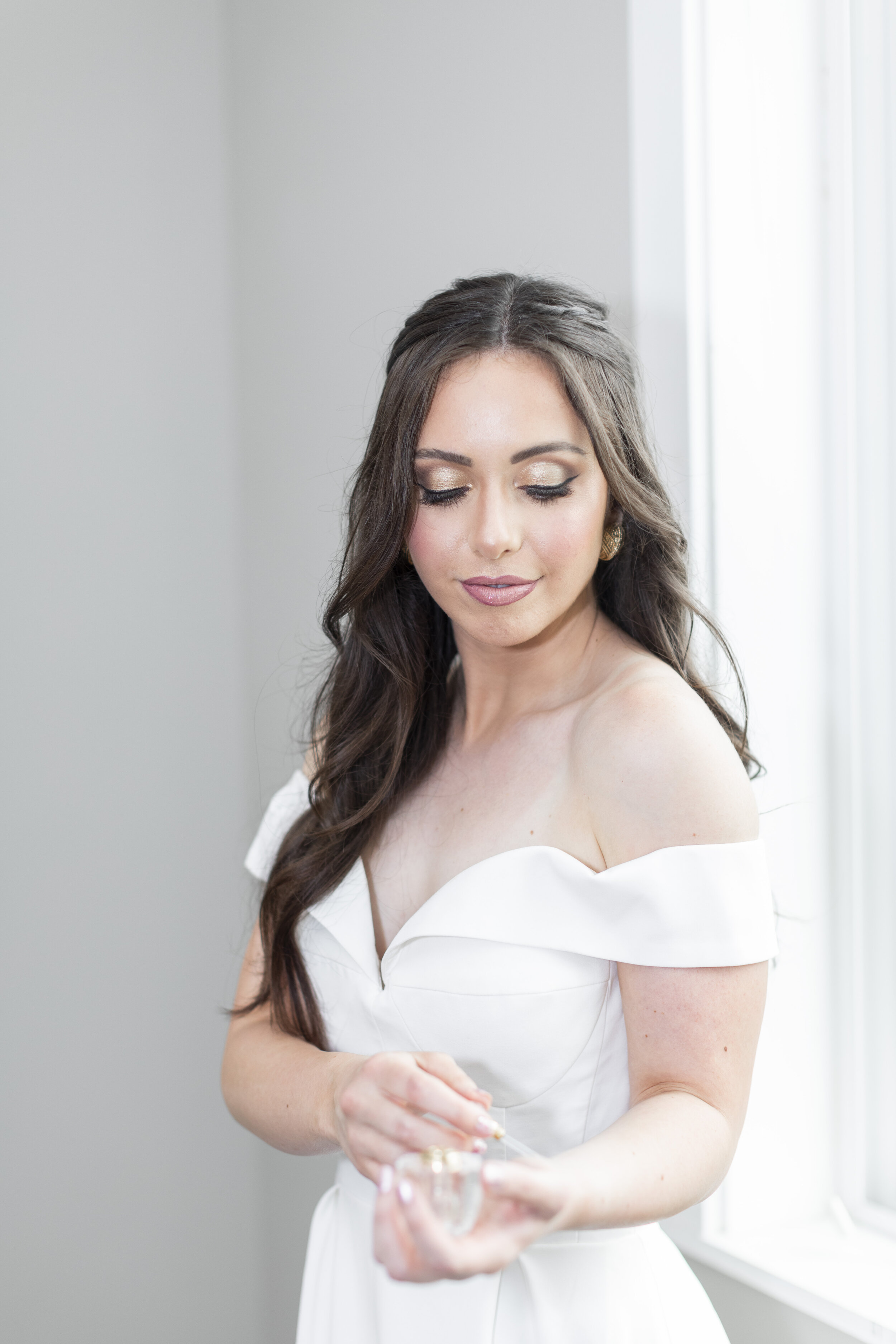  A stunning portrait of a bride next to a well-lit window in an off-the-shoulder wedding gown in Cache Valley Utah at a wedding day photographers workshop by Clarity Lane Photography. perfect indoor wedding lighting sweetheart gown #claritylanephotog