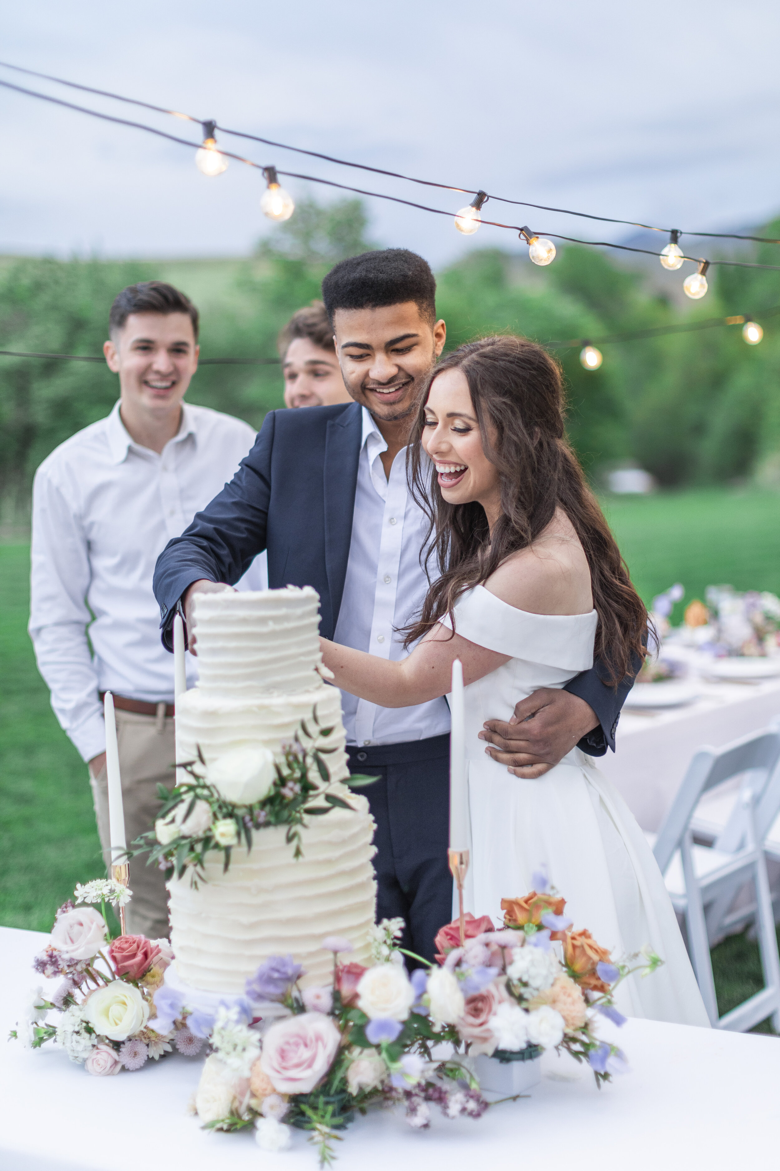  Clarity Lane Photography captures a photo of the bride and groom cutting the wedding cake together during a workshop where she helps other photographers learn tips in Cache Valley Utah. cut the wedding cake wedding day workshop #claritylanephotograp