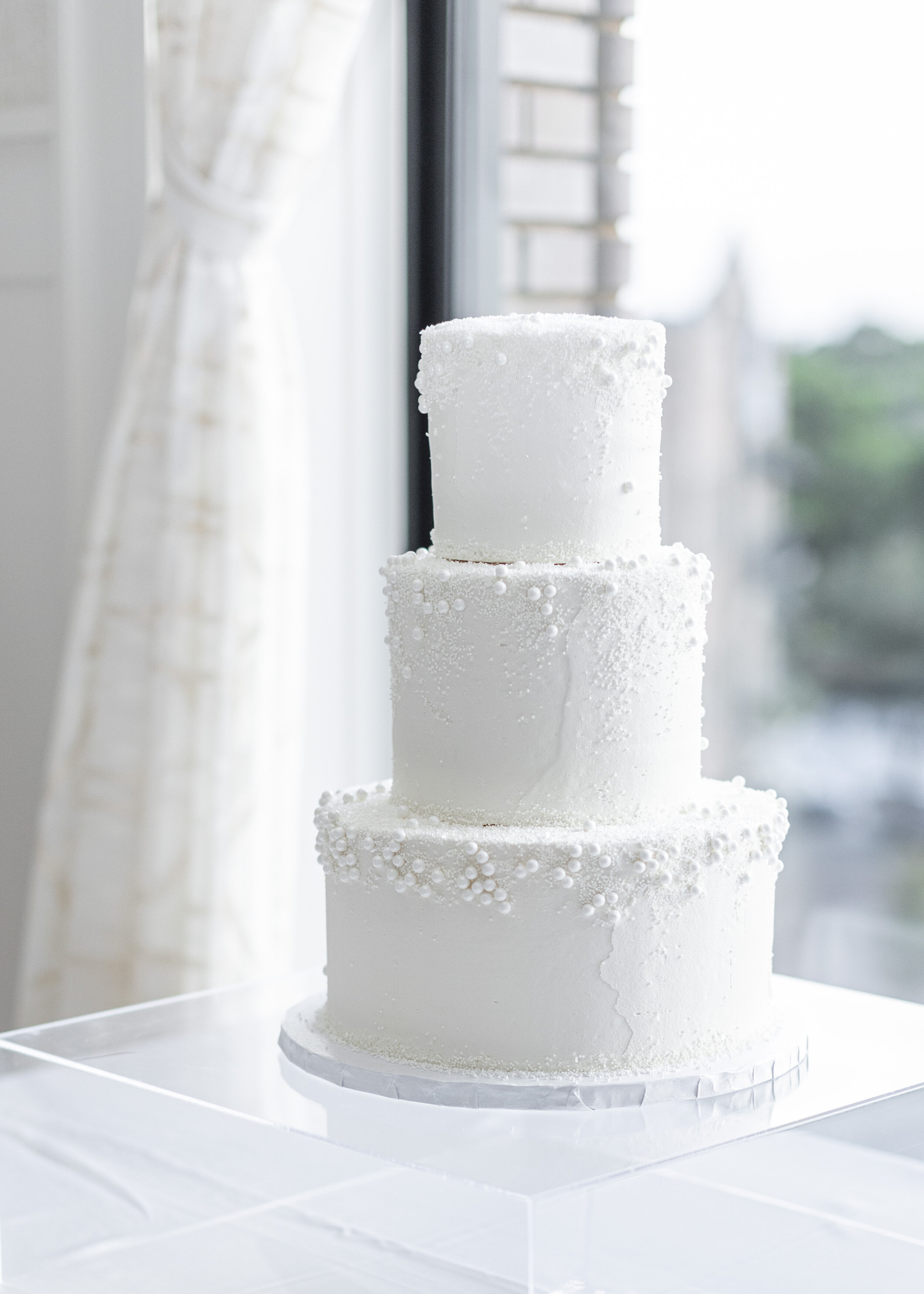  An all-white wedding cake on a clear cake stand makes for a simple yet upscale look. Wedding tablescape wedding cake inspiration white wedding cake high end wedding cake hotel vin grapevine wedding dallas texas wedding photographer wedding cake idea