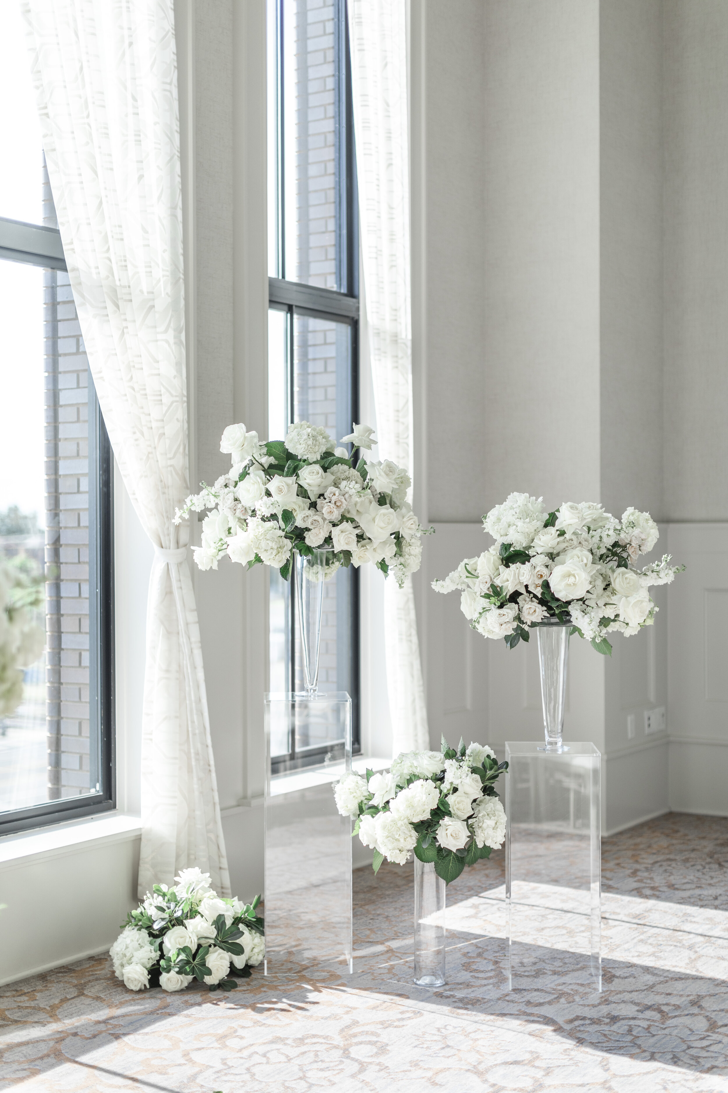  Tiered white flowers on display for an elegant wedding in Grapevine, TX. Ideas for a black and white wedding elegant wedding how to make your wedding high-end white floral inspiration flower ideas how to decorate a wedding with white flowers savanna