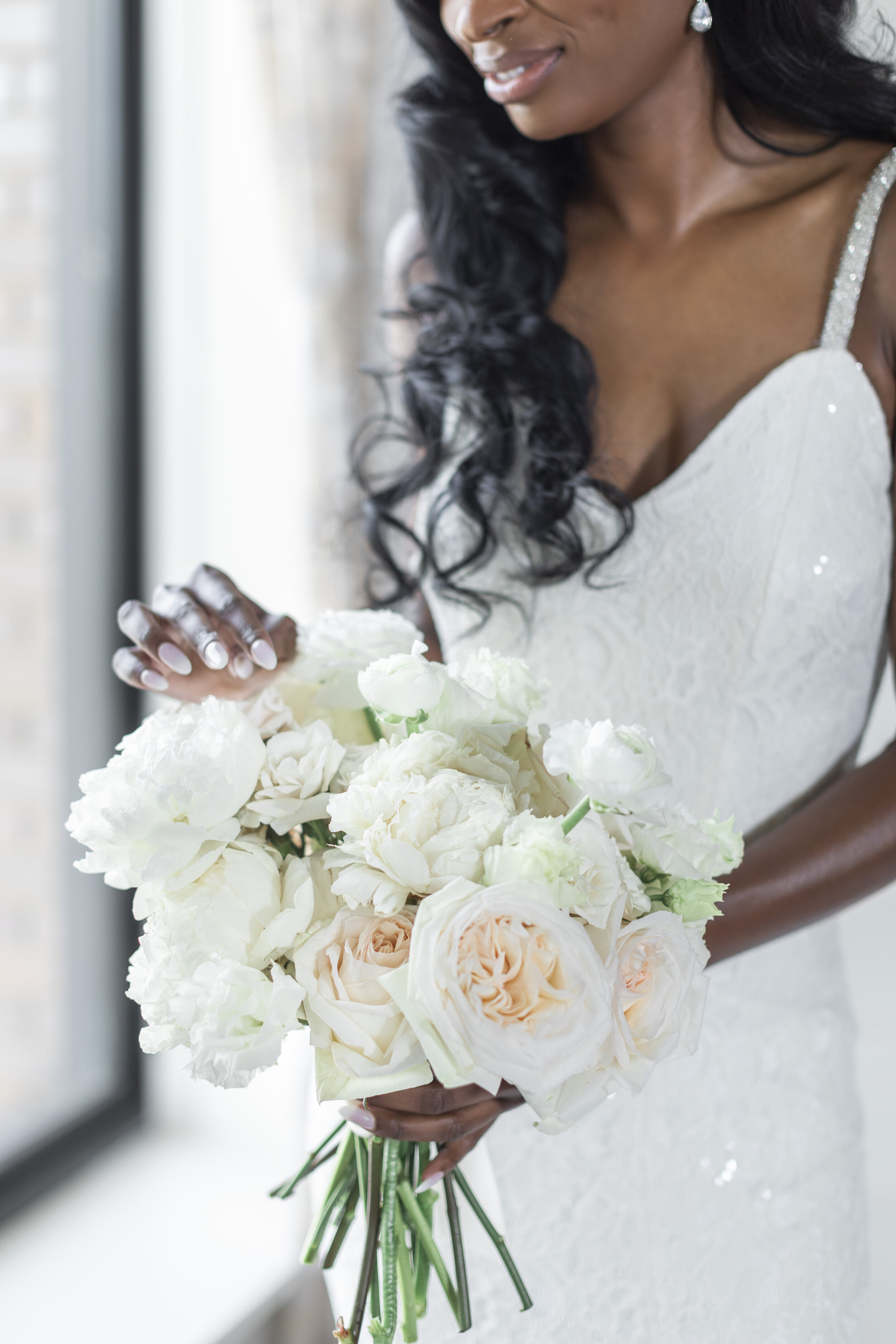 A lovely bride posing with her bouquet containing white flowers with touches of blush. Wedding bouquet inspiration white wedding bouquet savanna richardson photography elegant wedding ideas fort worth texas wedding photographer blush wedding flowers