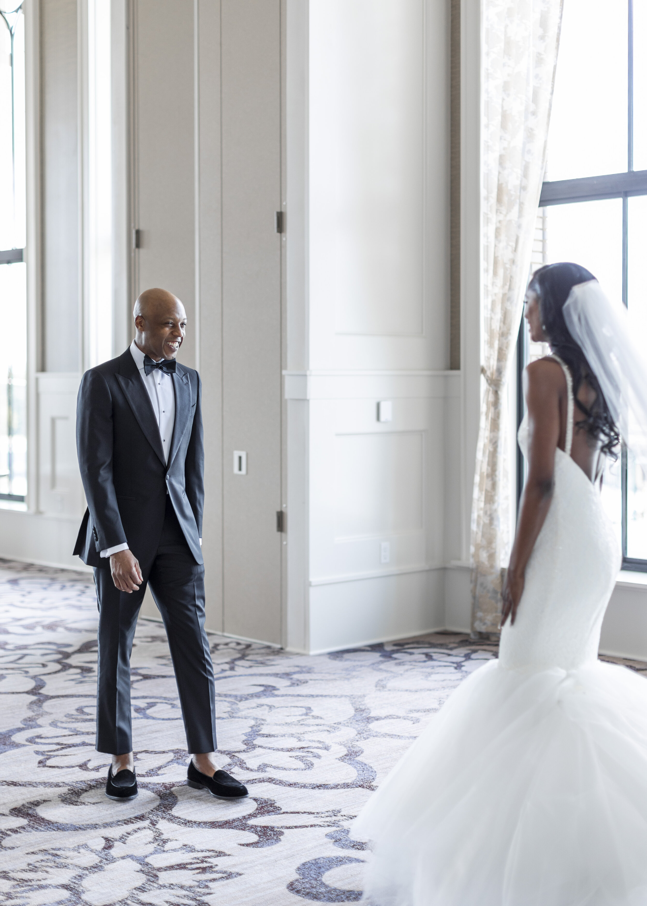  A groom seeing his beautiful bride for the first time on their wedding day. First look wedding photo ideas elegant wedding outfits wedding dress inspiration dallas wedding ideas mermaid wedding dress wedding veil groom outfit ideas shoes for the gro