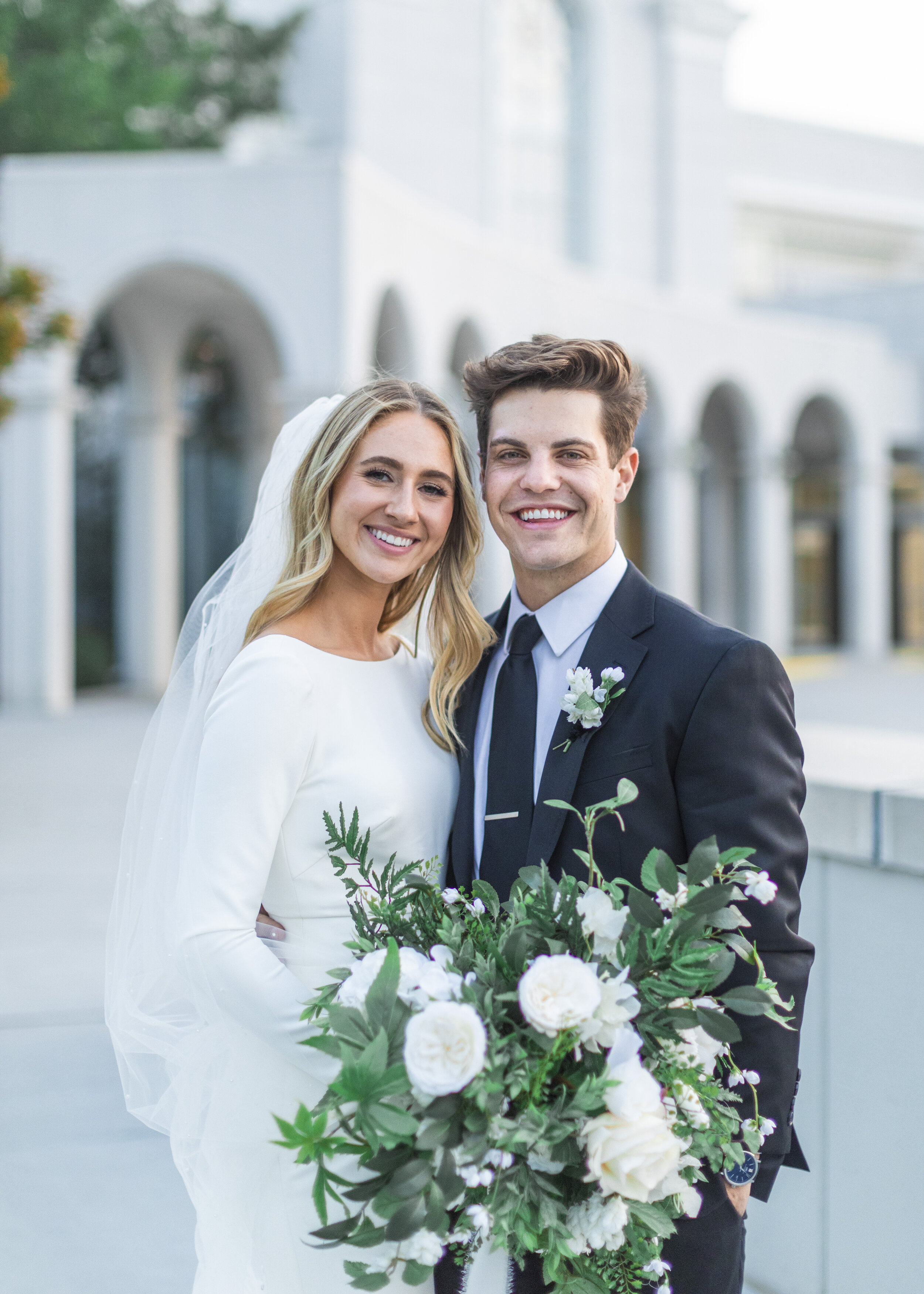  Newly married couple smiles for a wedding shot outside of the Utah Bountiful Temple during a wedding formal session with Savanna Richardson Photography. Bountiful temple wedding photos bountiful wedding photographer summer wedding portraits #savanna