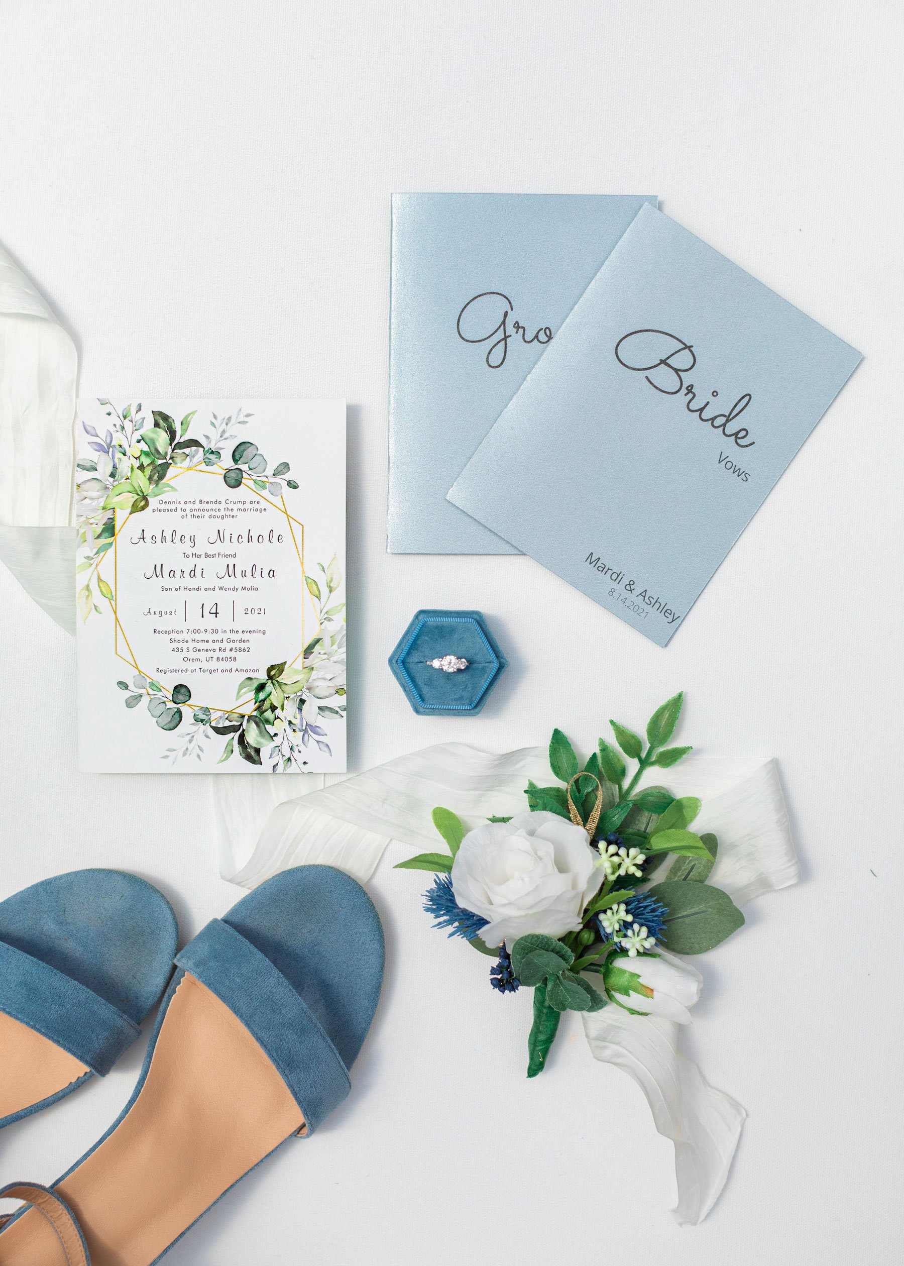  Bridal flat-lay with blue high heels and flower invitation and wedding ring in the blue box by Savanna Richardson Photography in Orem, Utah. floral boutonniere wedding ring flat-lay blue bridal shoes bride and groom vows #savannarichardsonphotograph
