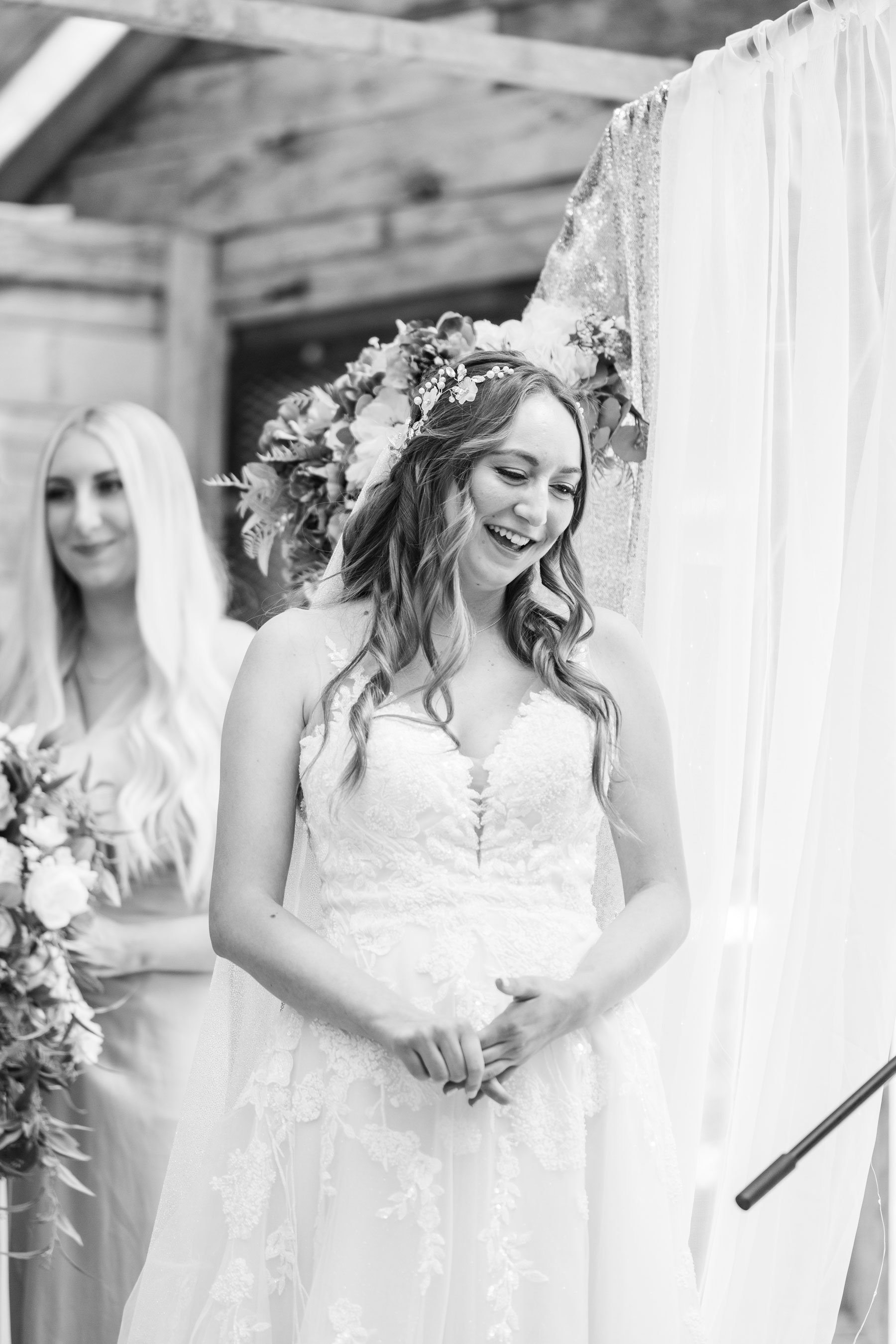  A beautiful bride with a floral crown and sweetheart neckline wedding dress smiles as she gets to the end of the aisle by Savanna Richardson Photography in Utah County. bride at the altar floral wedding crown fitted wedding gown #savannarichardsonph