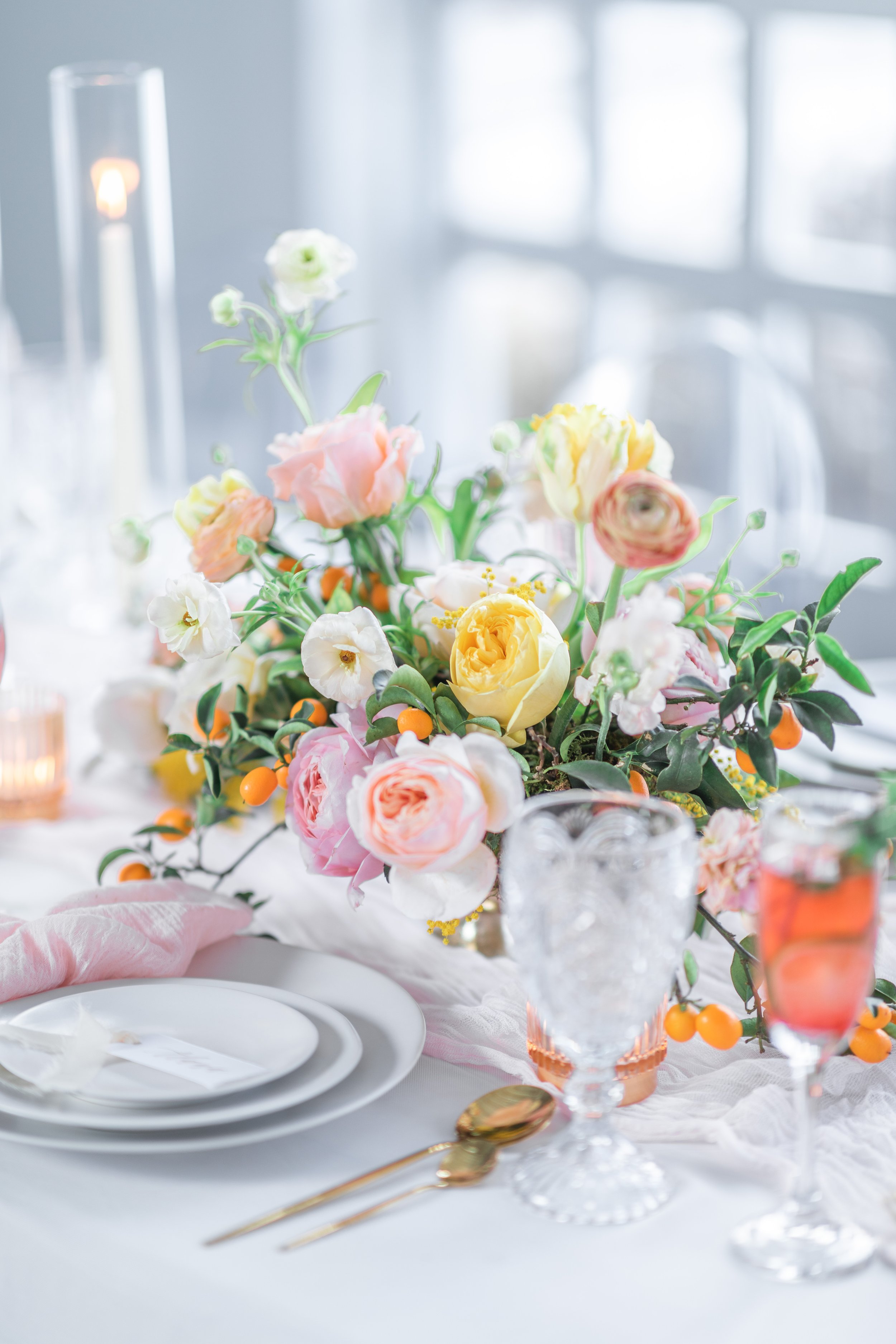  Savanna Richardson Photography captures a spring-inspired wedding table with a pink and yellow centerpiece. floral centerpiece glass goblet #savannarichardsonphotography #utahvendor #utahweddingphotographer #MilleFleurDesign #Utahweddingdesigns 