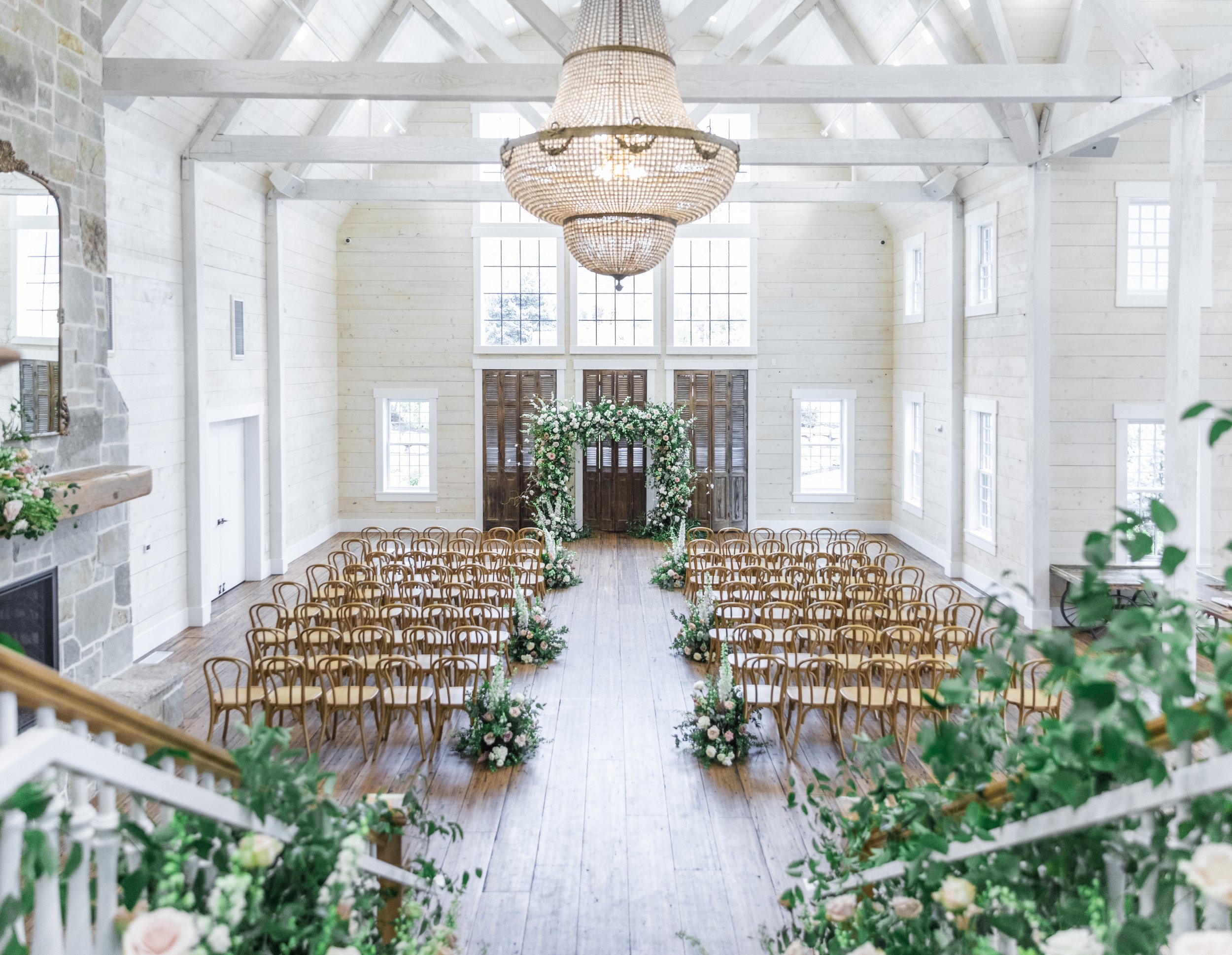  An indoor Utah wedding venue with rustic chairs and fresh greenery captured by Savanna Richardson Photography. Utah wedding venues fresh florals #savannarichardsonphotography #utahvendor #utahweddingphotographer #MilleFleurDesign #Utahweddingdesigns