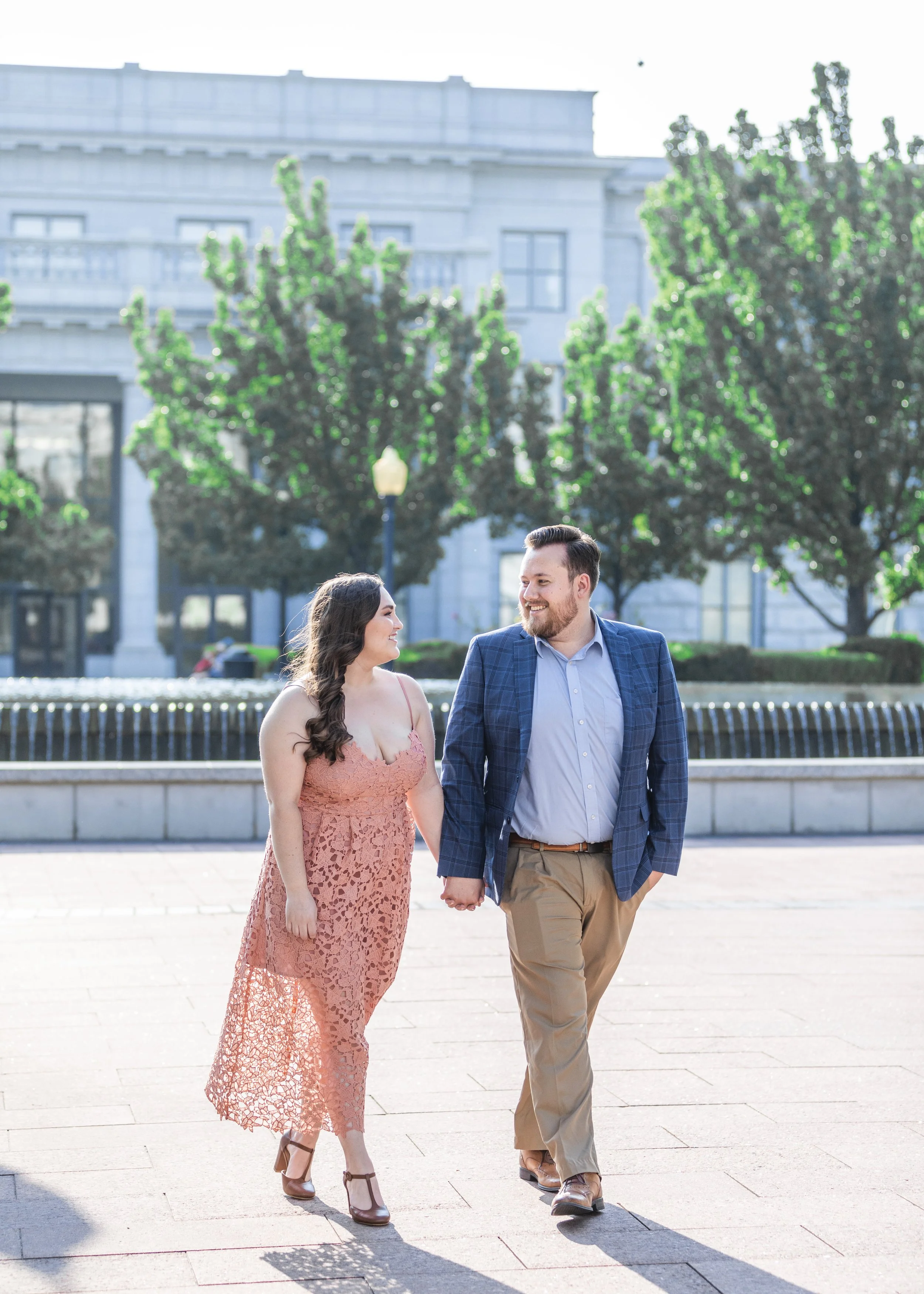  Walking around the Capitol Building a couple smile at each other by Savanna Richardson Photography. SLC engagements SLC photographers summer wedding #savannarichardsonphotography #Utahcapitolphotography #utahengagements #utahengagementphotographer 