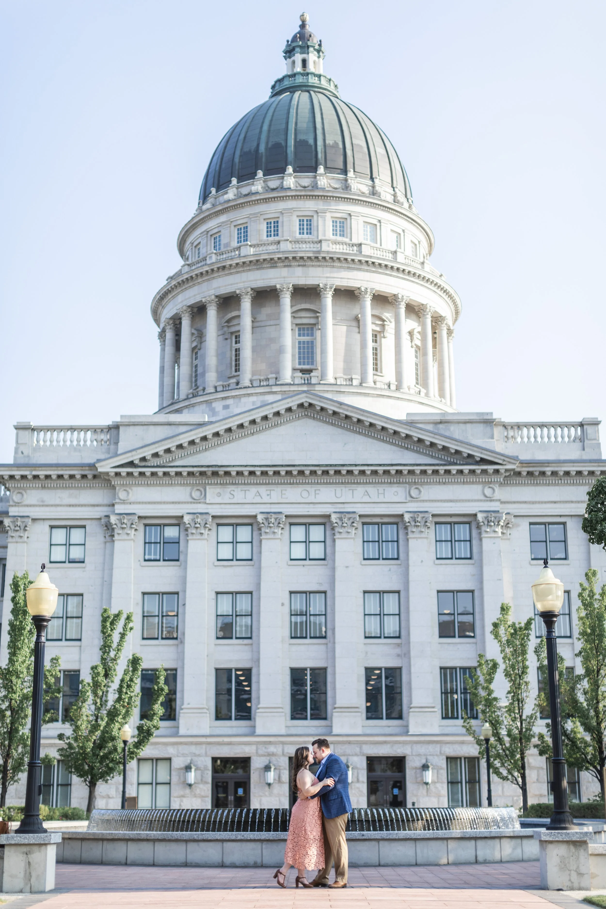  At the Utah State Capitol Building, a couple kisses during an engagement session with professional Savanna Richardson Photography. UT couple shots #savannarichardsonphotography #Utahcapitolphotography #utahengagements #utahengagementphotographer 