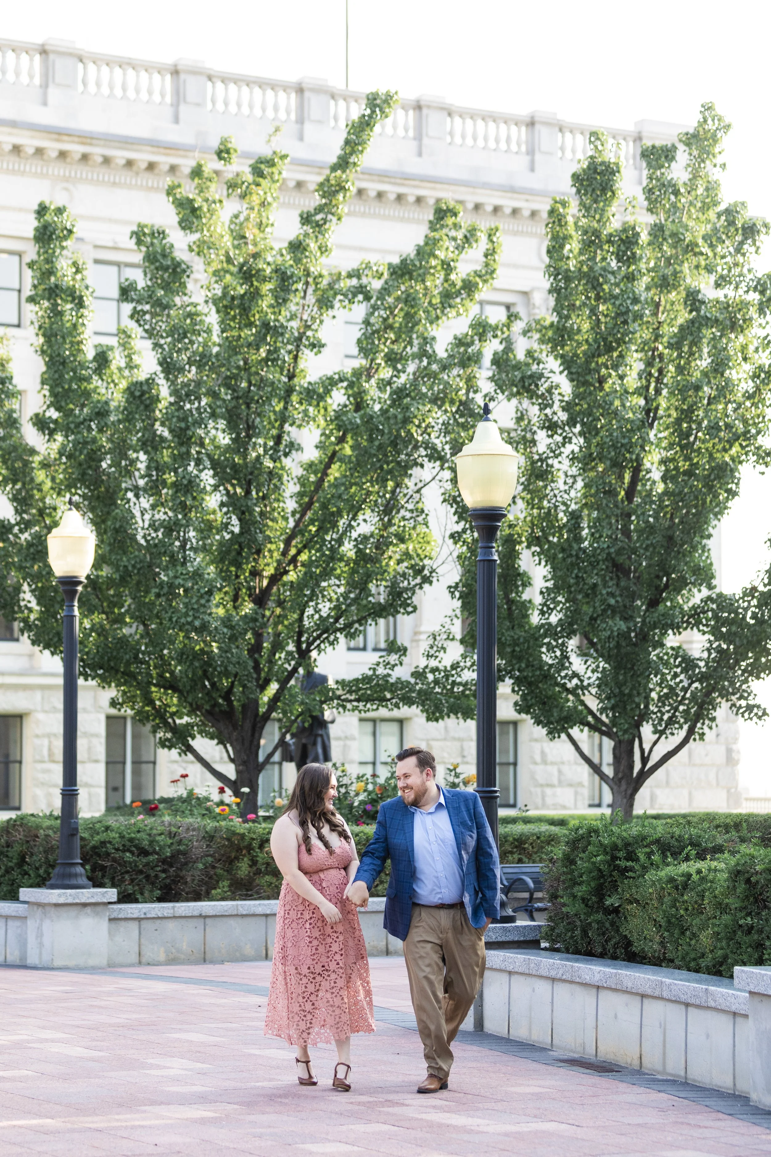  An engaged couple holds hands at the Utah State Capitol captured by Savanna Richardson Photography. SLC engagement photographer Utah State Capitol #savannarichardsonphotography #Utahcapitolphotography #utahengagements #utahengagementphotographer 