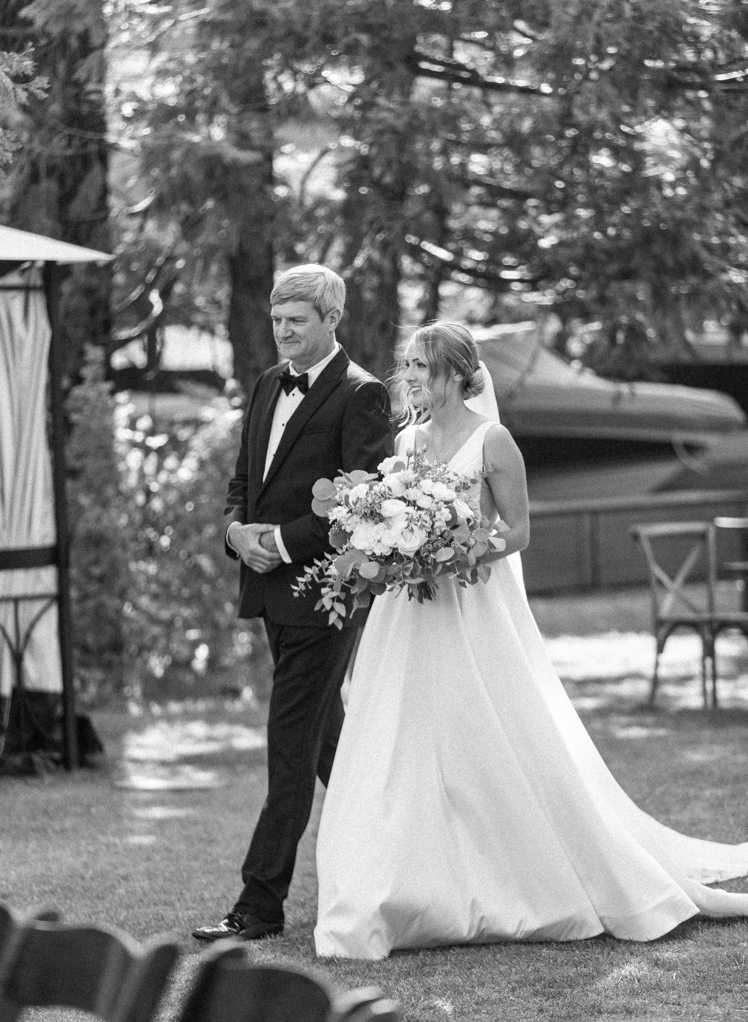  Father of the bride, arm in arm with the bride walks his daughter down the aisle by Savanna Richardson Photography. father of the bride #savannarichardsonphotography #tahoewedding #lakesidewedding #outdoorwedding #summerwedding #laketahoe 