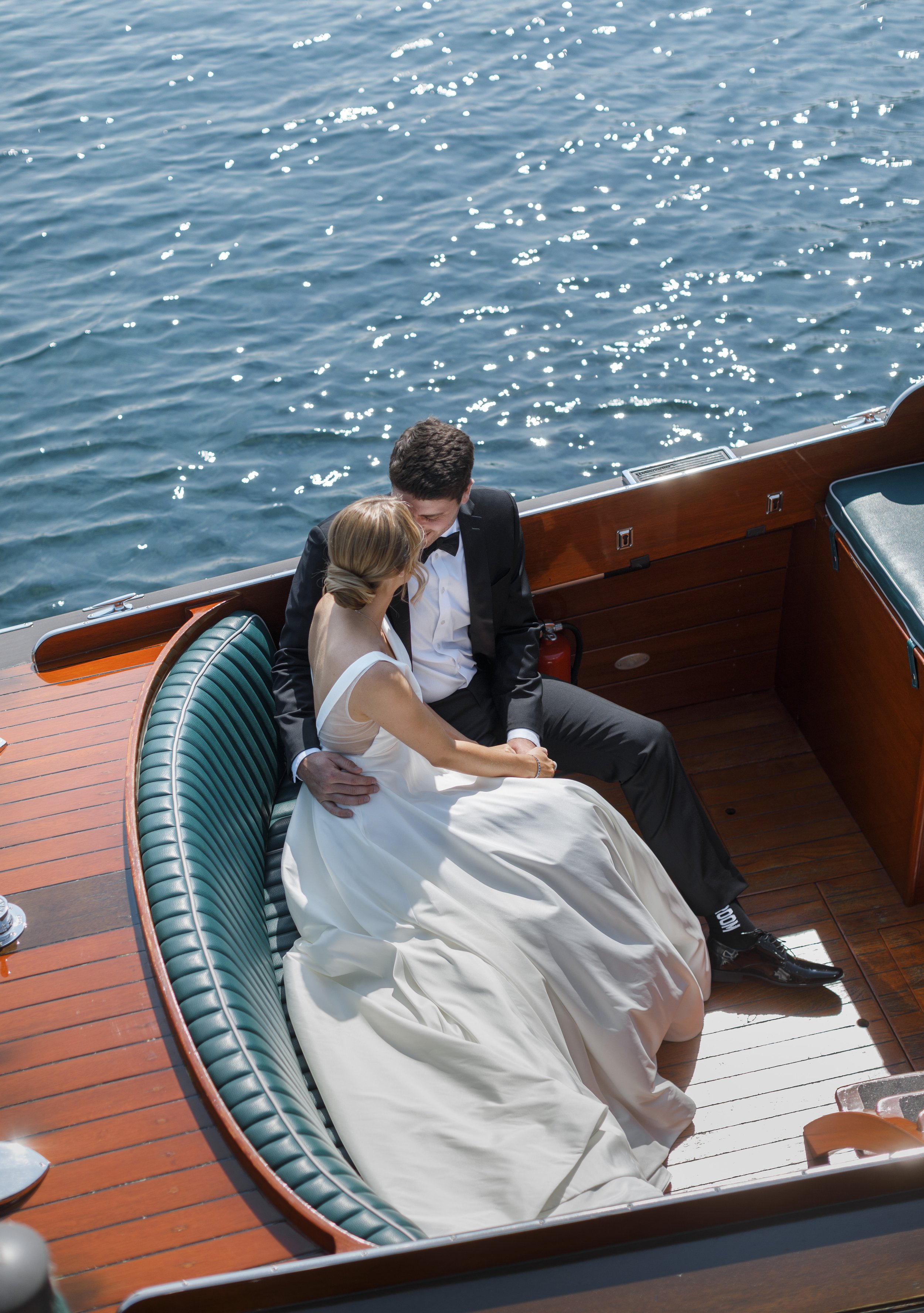  Bride and groom snuggle together while riding on a boat captured by Savanna Richardson Photography. bride and groom boat pictures water weddings #savannarichardsonphotography #tahoewedding #lakesidewedding #outdoorwedding #summerwedding #laketahoe 