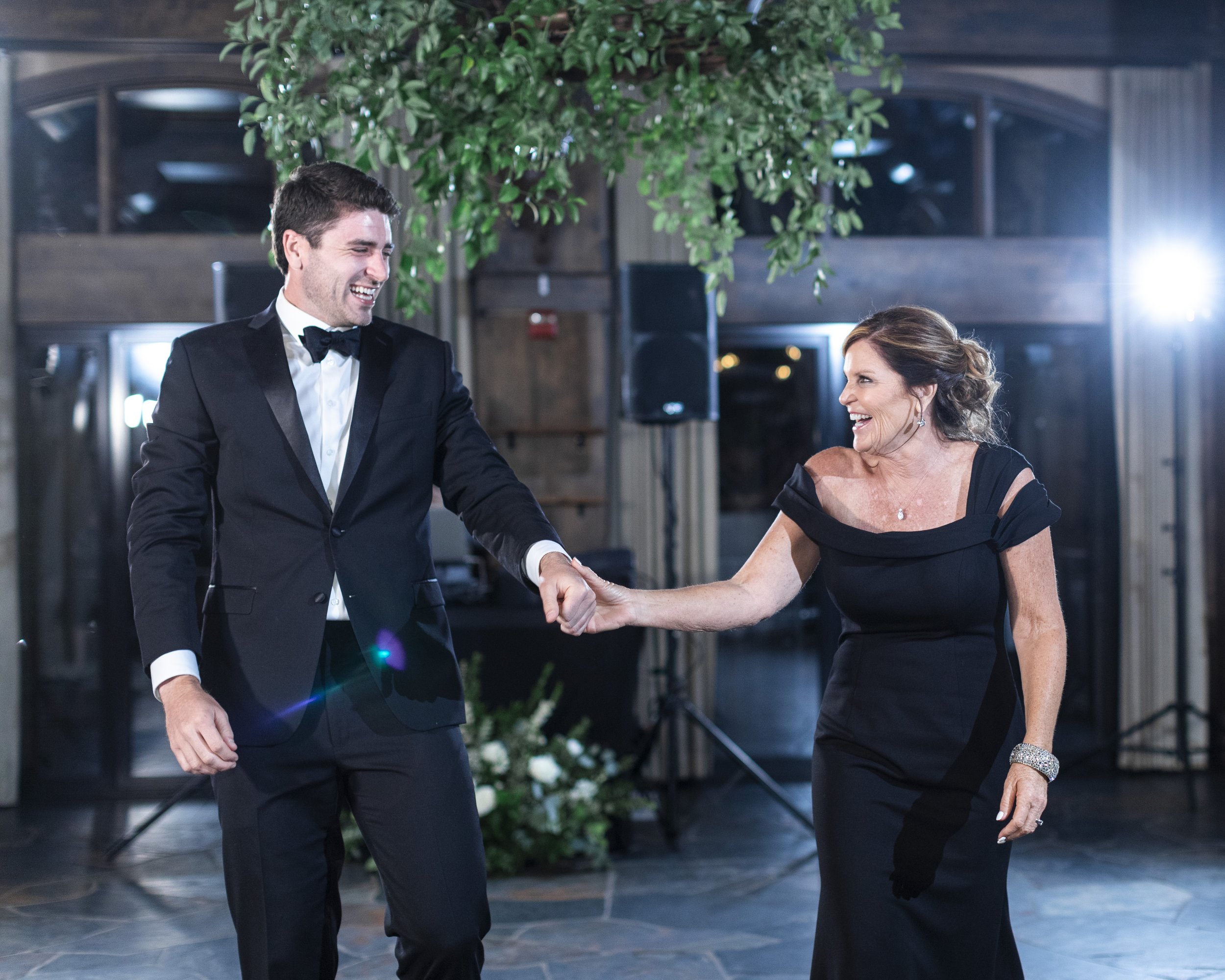  A groom leads his mother out onto the dance floor captured by wedding photographer Savanna Richardson Photography. Lake Tahoe wedding photographers #savannarichardsonphotography #tahoewedding #lakesidewedding #outdoorwedding #summerwedding #laketaho