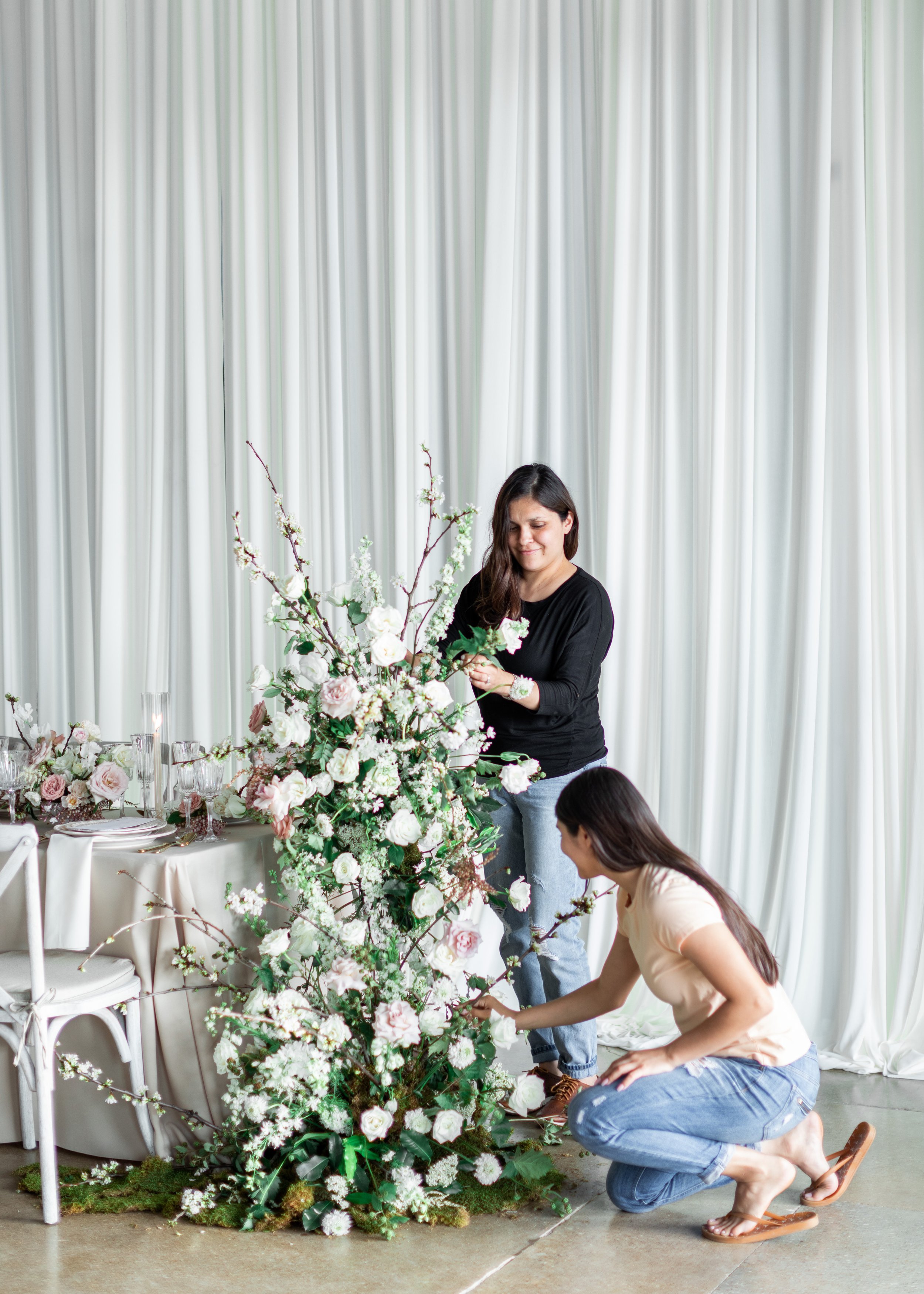  Portrait of two florists arranging floral pillars for wedding captured by Savanna Richardson Photography. florists at wed wedding planner #savannarichardsonphotography #weddingplannervsvenuecooridnator #weddingphotographer #weddingphotographersUtah 